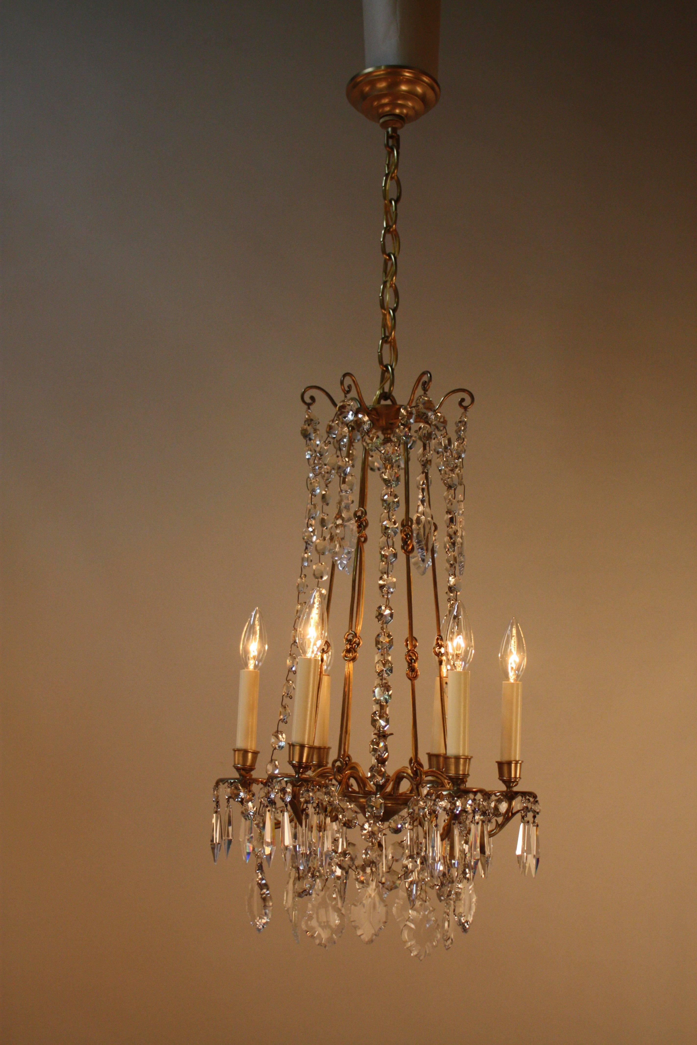 Elegant six-light 19th century crystal chandelier. Originally burning candle that professorially has been electrified.