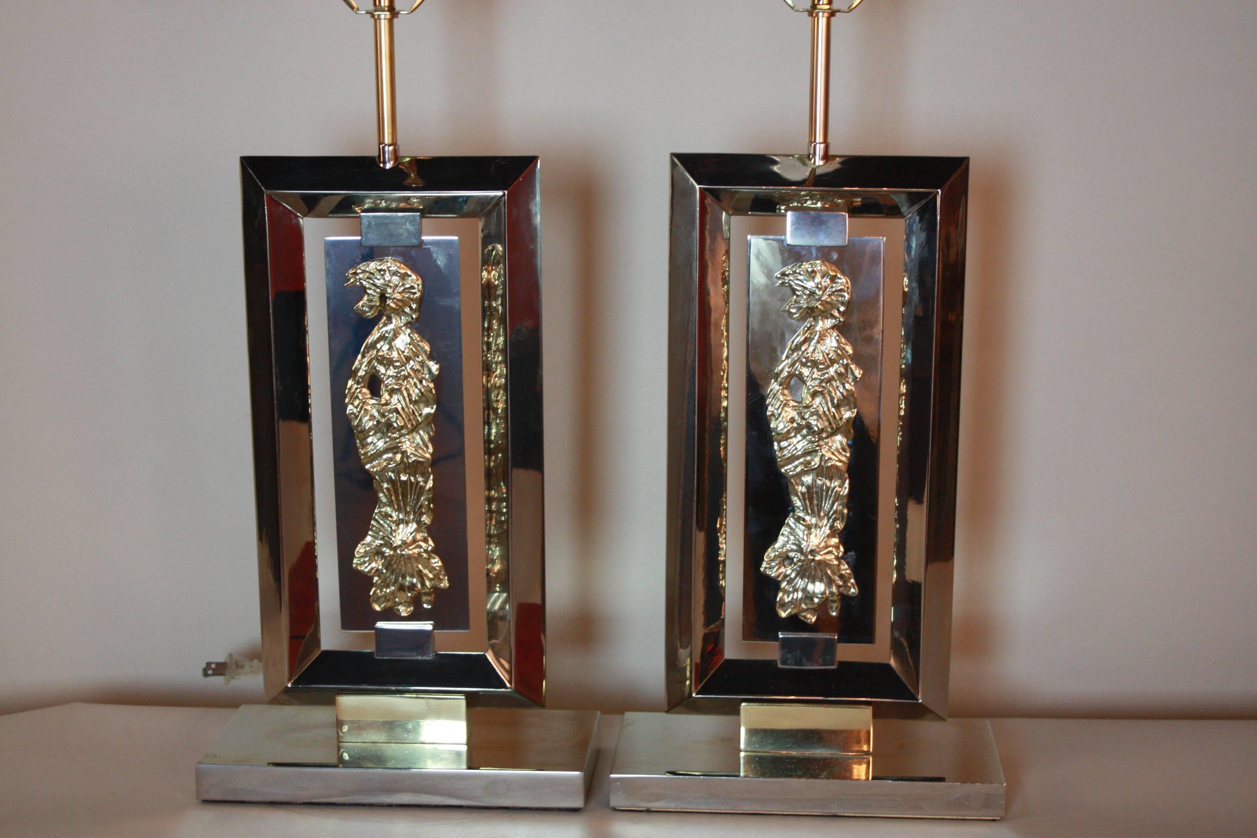 Pair of modern nickel on bronze table lamps with fantastic bronze sculpture of woman over a nickel plaque in the center of these oblong lamps.
Total height of the is 30