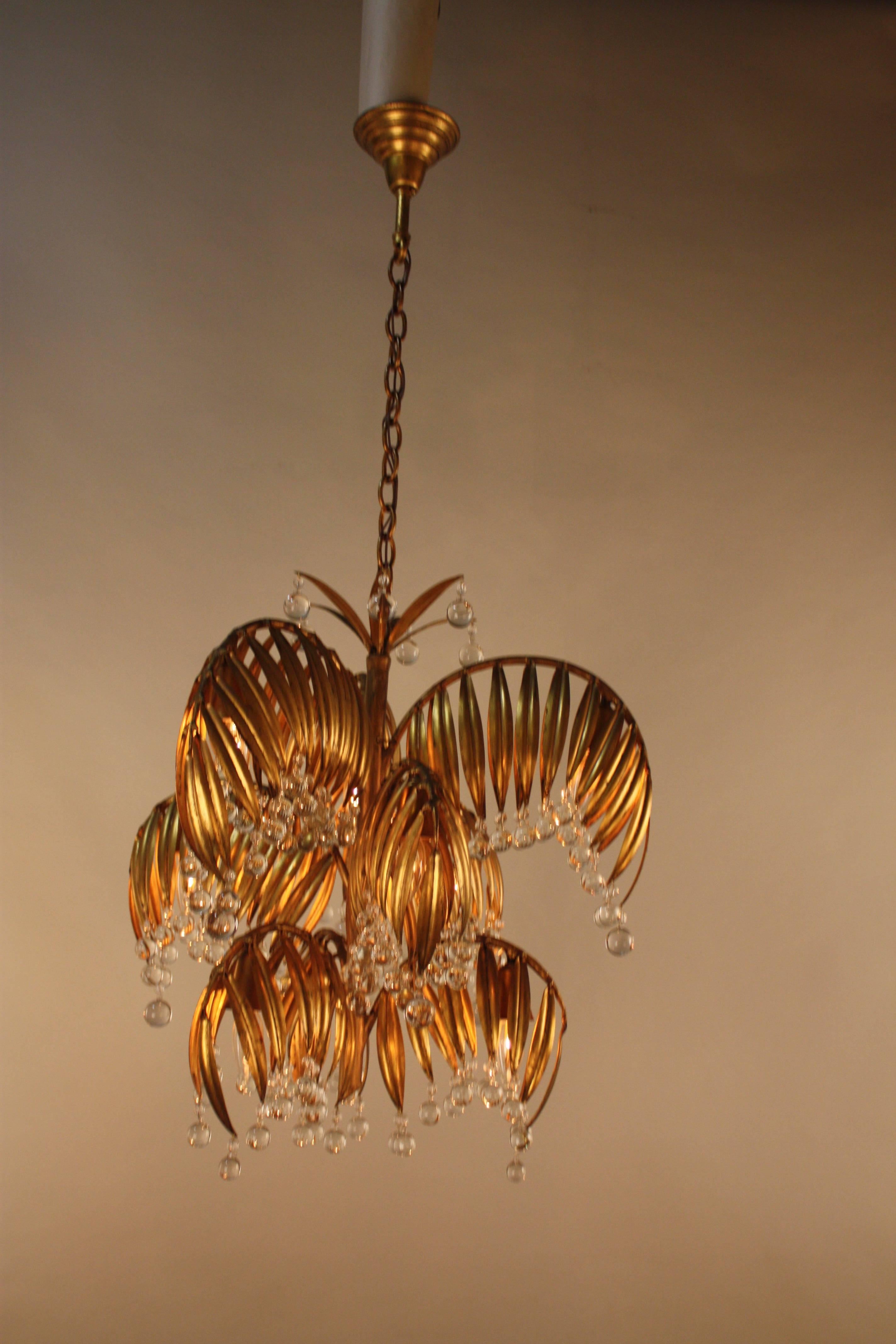 Beautifully handcrafted in Italy during 1950s, gold leaf chandelier with crystal drops.
Total of nine lights 60watts each.
Measure: Minimum height fully installed is 32