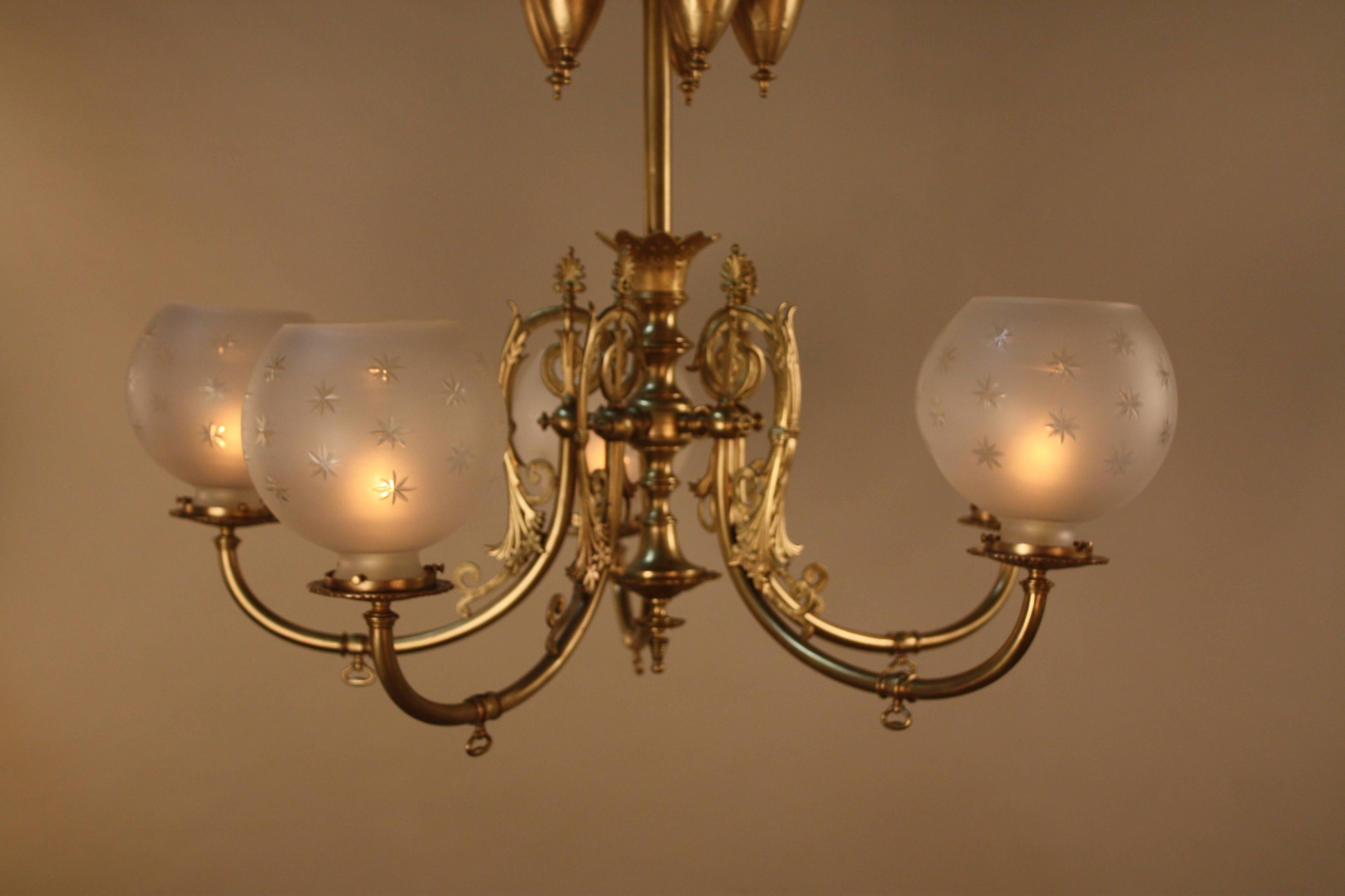 Late 19th century American brass gas chandelier five-star cut-glass shades.
Electrified 60 watts max each light.
