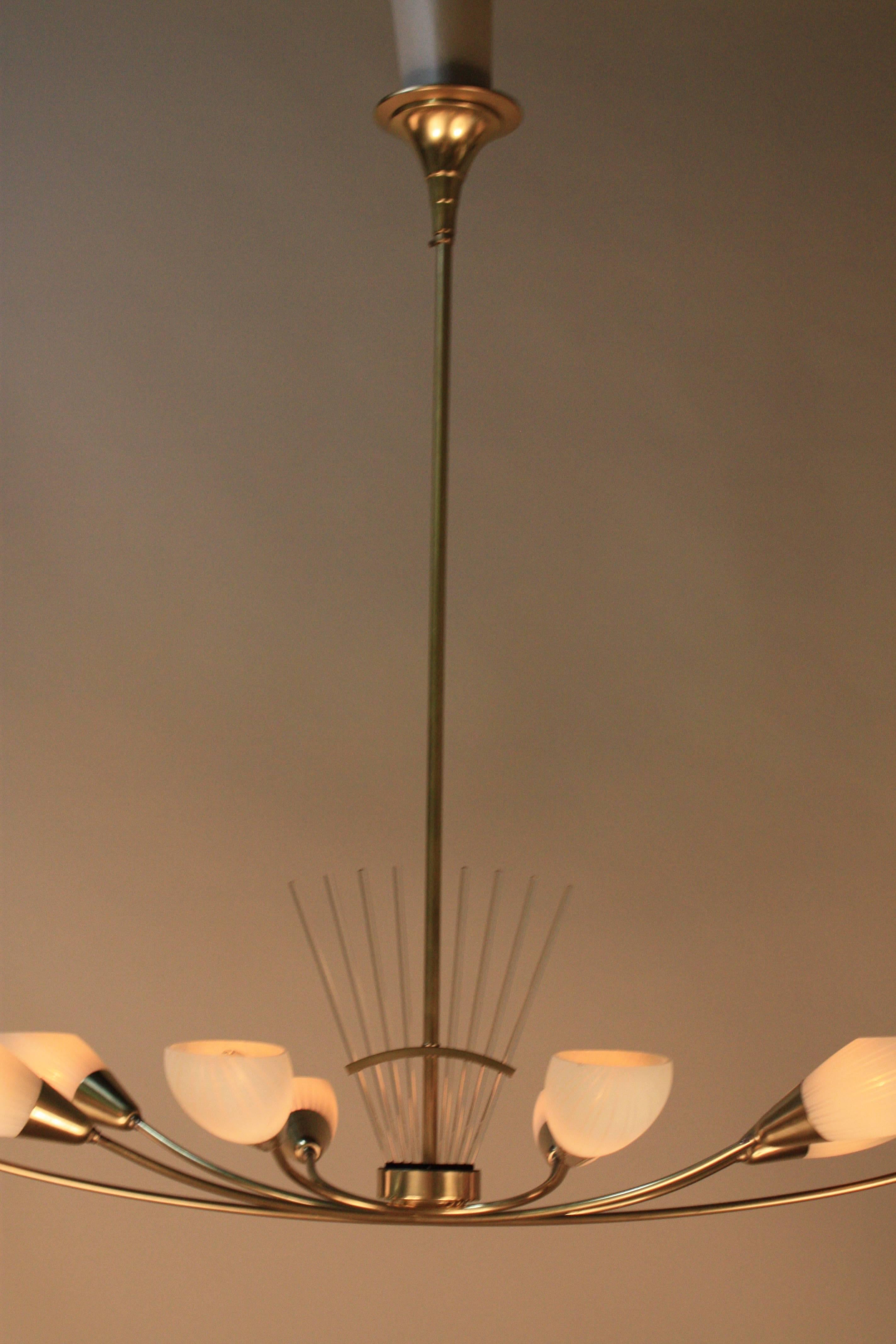 French Mid-Century Modern bronze chandelier designed with ten glass shades and crystal rod in the center.