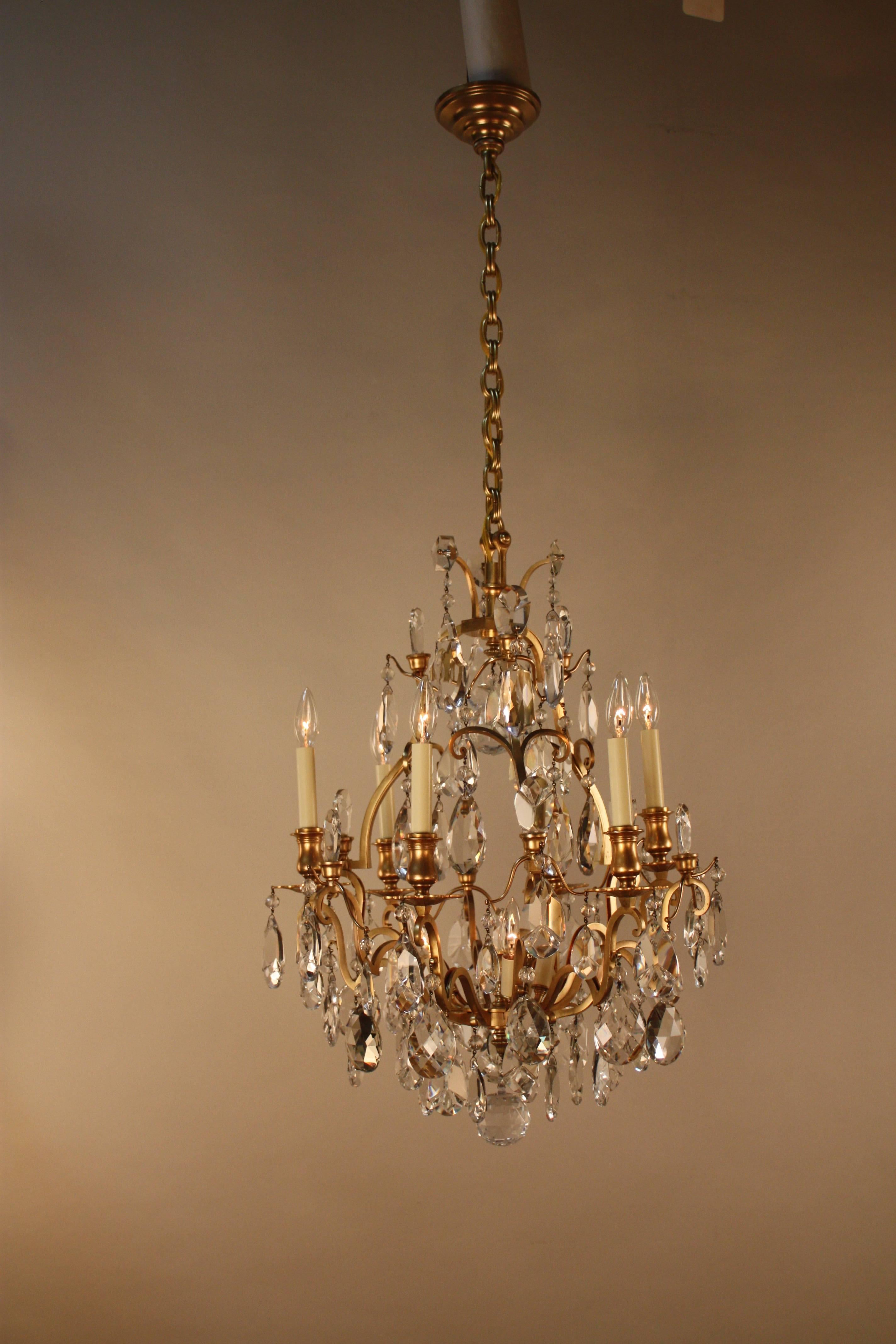 High quality hand-cut crystal with elegant bronze design frame chandelier. 
Total of nine lights 60watts max each.
Minimum fully installed height is 34