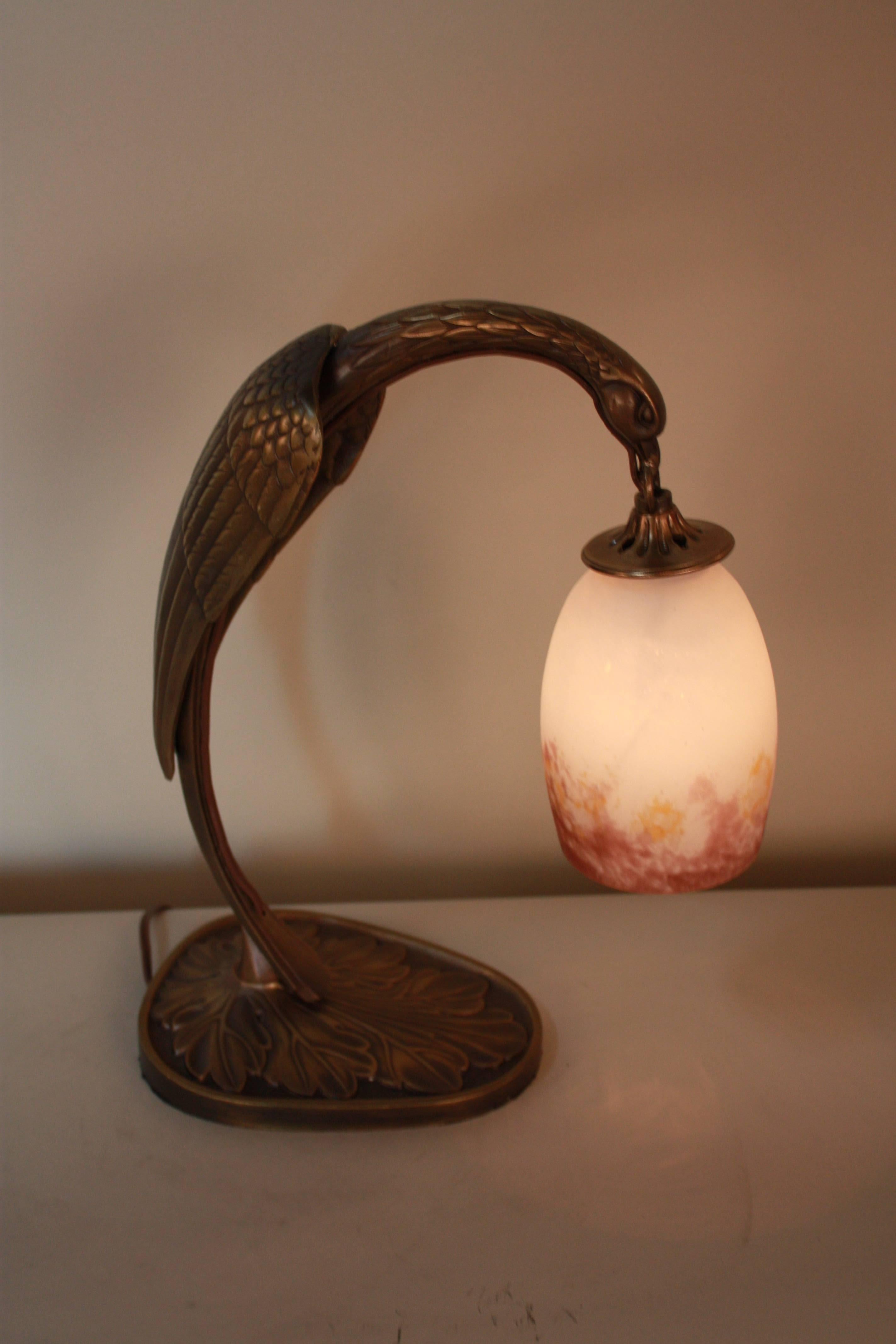 A fantastic bronze table lamp. Resembling the legendary phoenix, this lamp feature a stunning hand blow art glass shades.