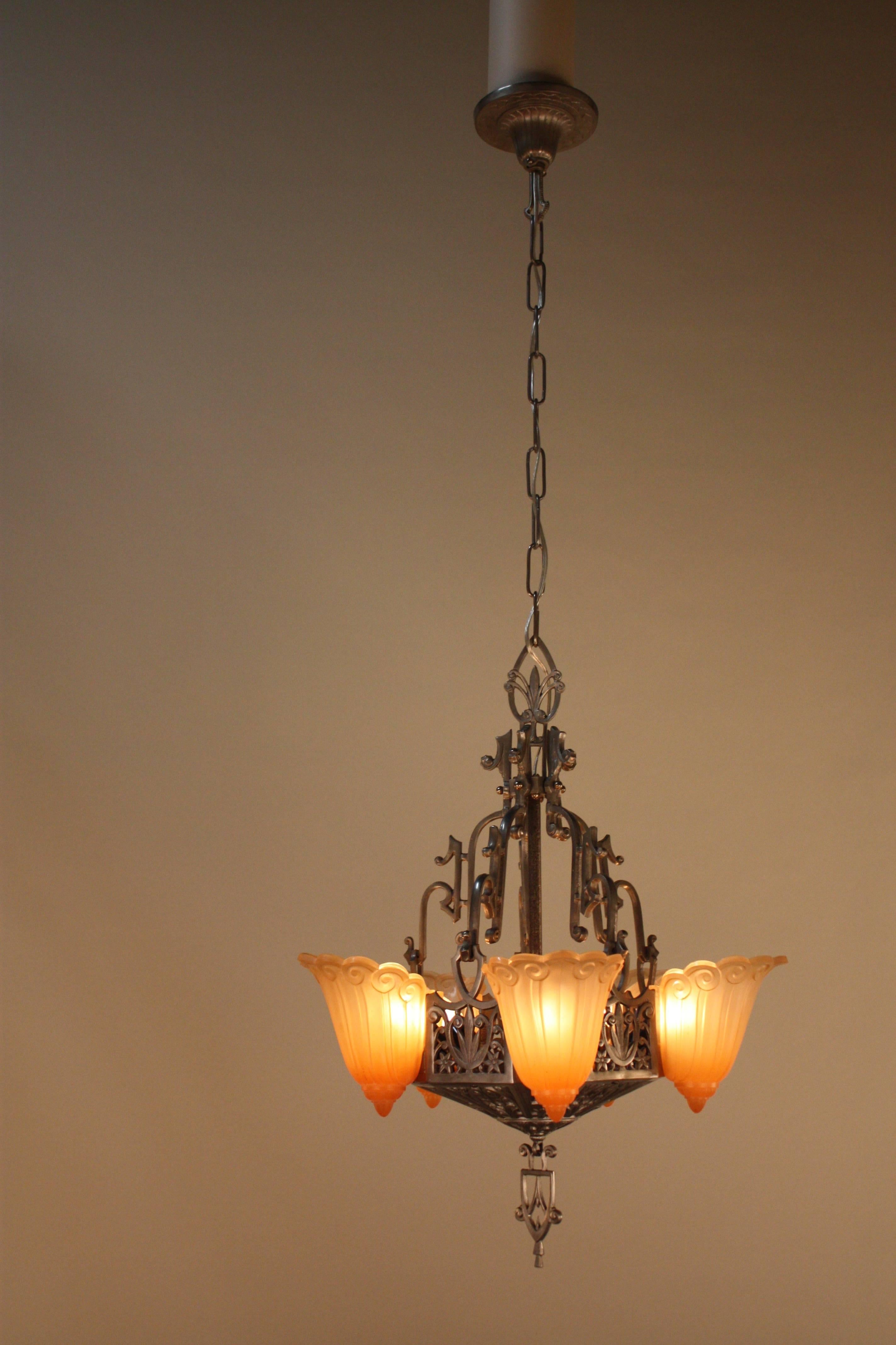 Five-light American slip shade chandelier with beautiful warm orange color shade and pewter color metal frame.