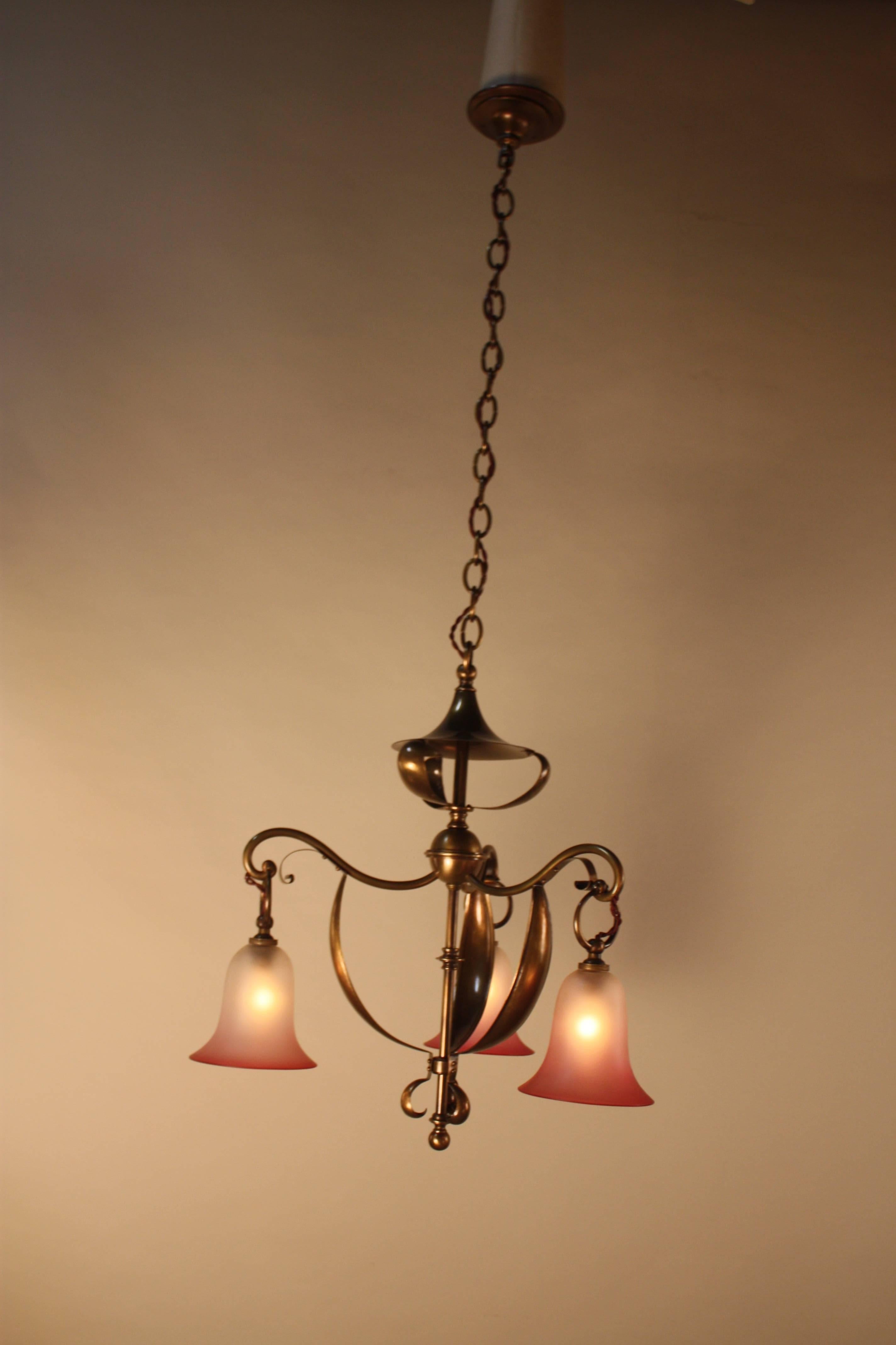 A fabulous English three-light semi oxidized brass Art Nouveau chandelier with beautiful glass shades.
The minimum height fully installed is 27