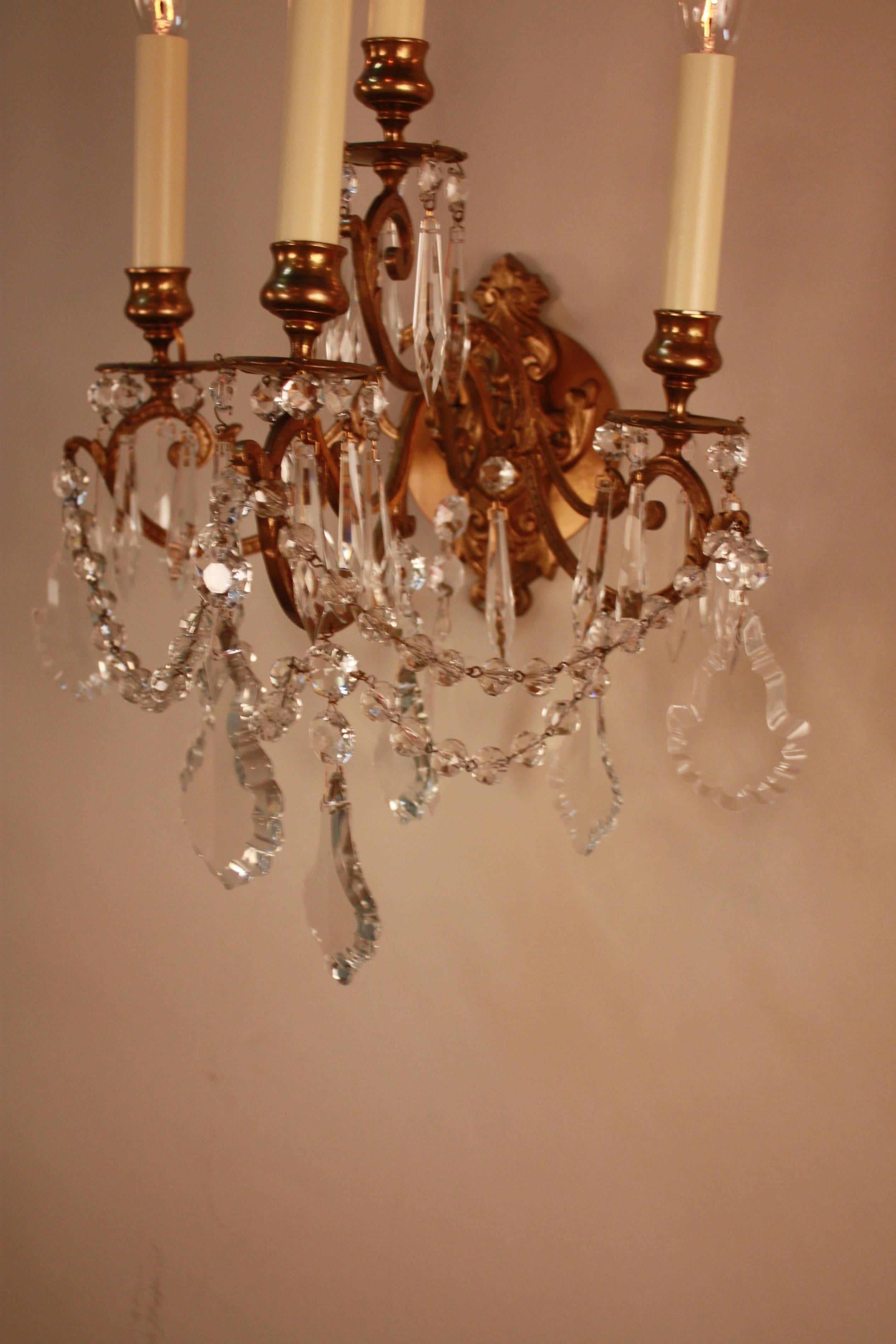 Pair of 19th century four-light crystal and bronze wall sconces.