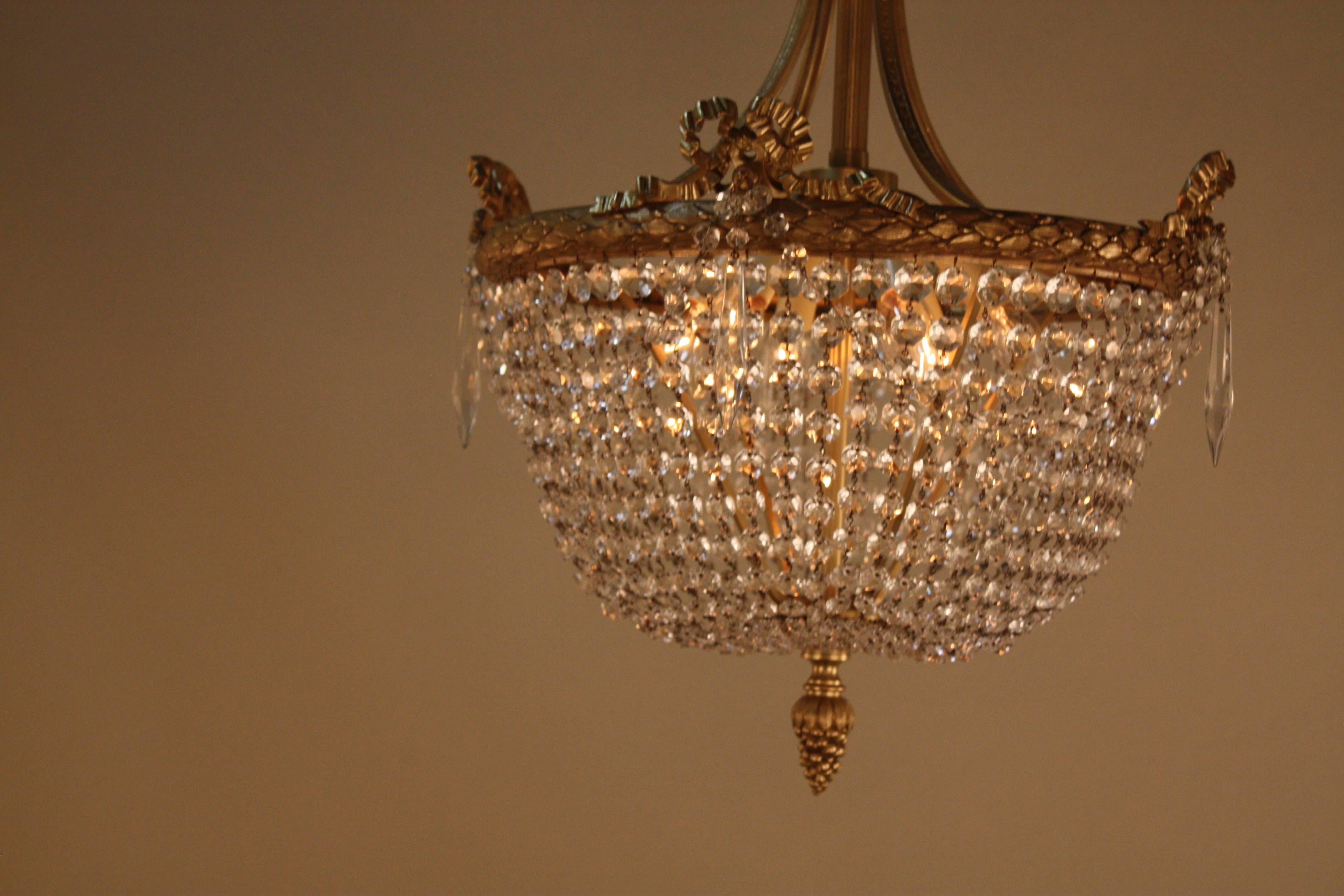 Beautifu French crystal basket with bronze chandelier.
Total of six lights 60watts each.