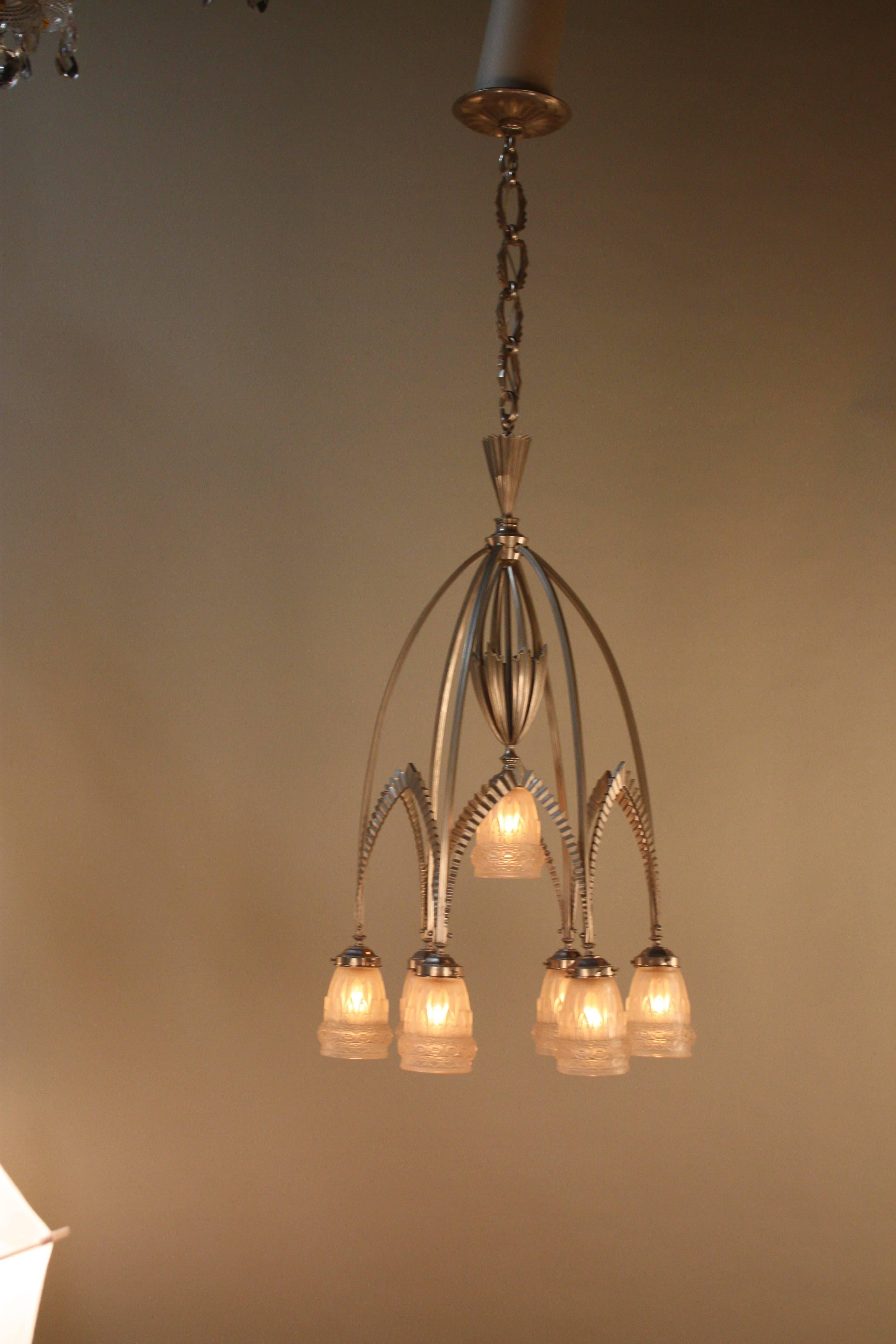 Seven heavy clear frost with high polished glass shades with nickel on bronze frame chandelier.