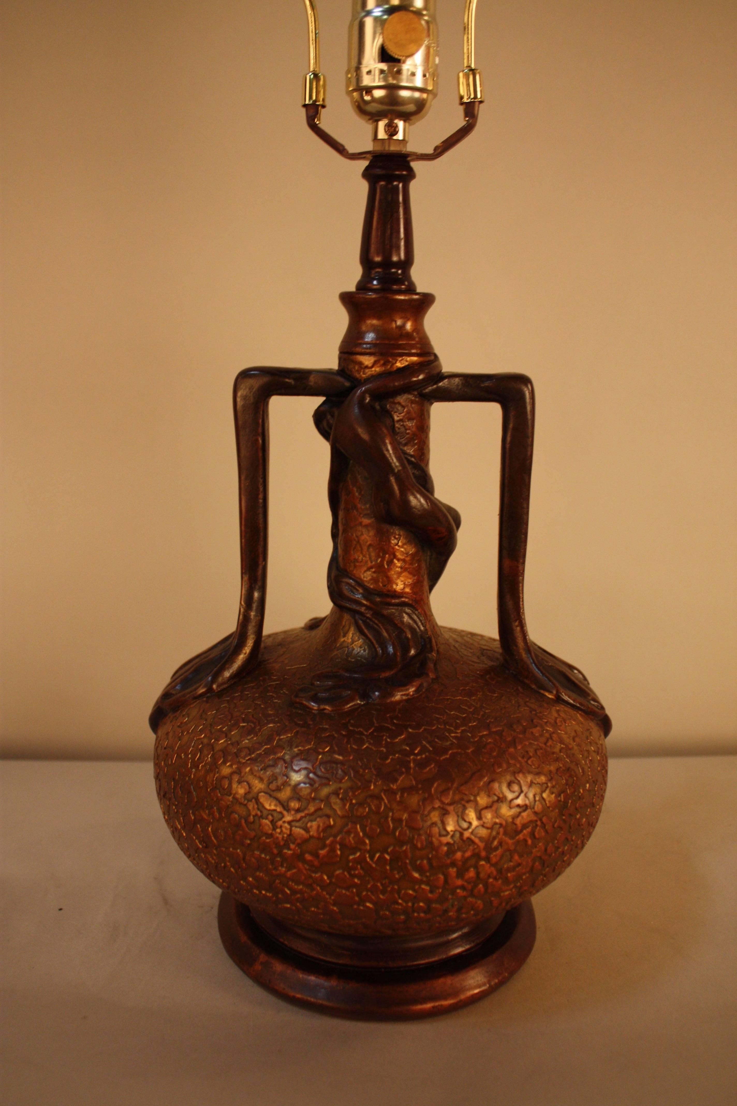 This gorgeous lamp has strong organic element as well as art nouveau influence by softly an woman has wrapped herself around upper part of the lamp.
Originally combination of gold plate oxidized over copper but the gold has been semi oxidized. 

