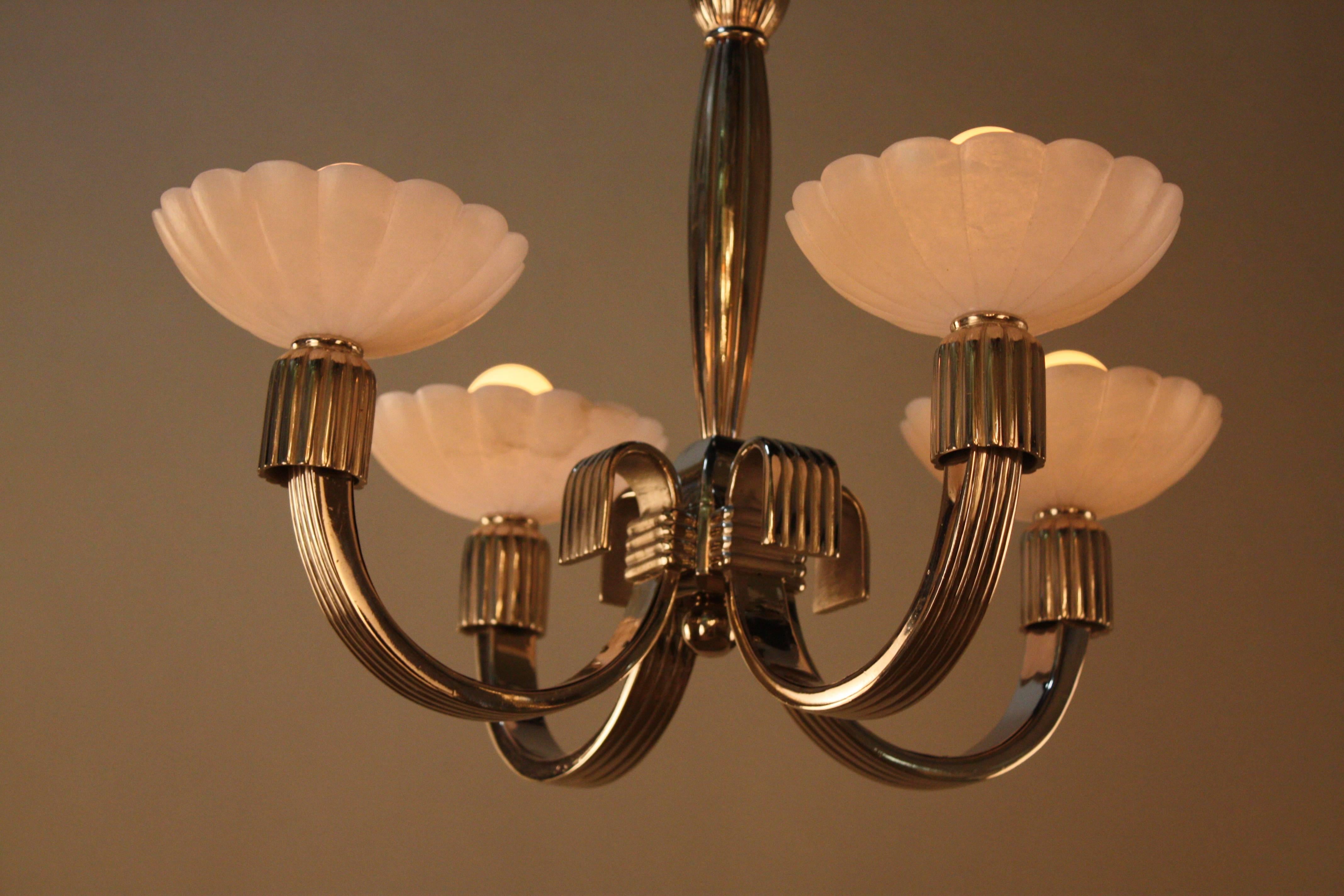 Simple but elegant nickel on bronze chandelier with alabaster shades.