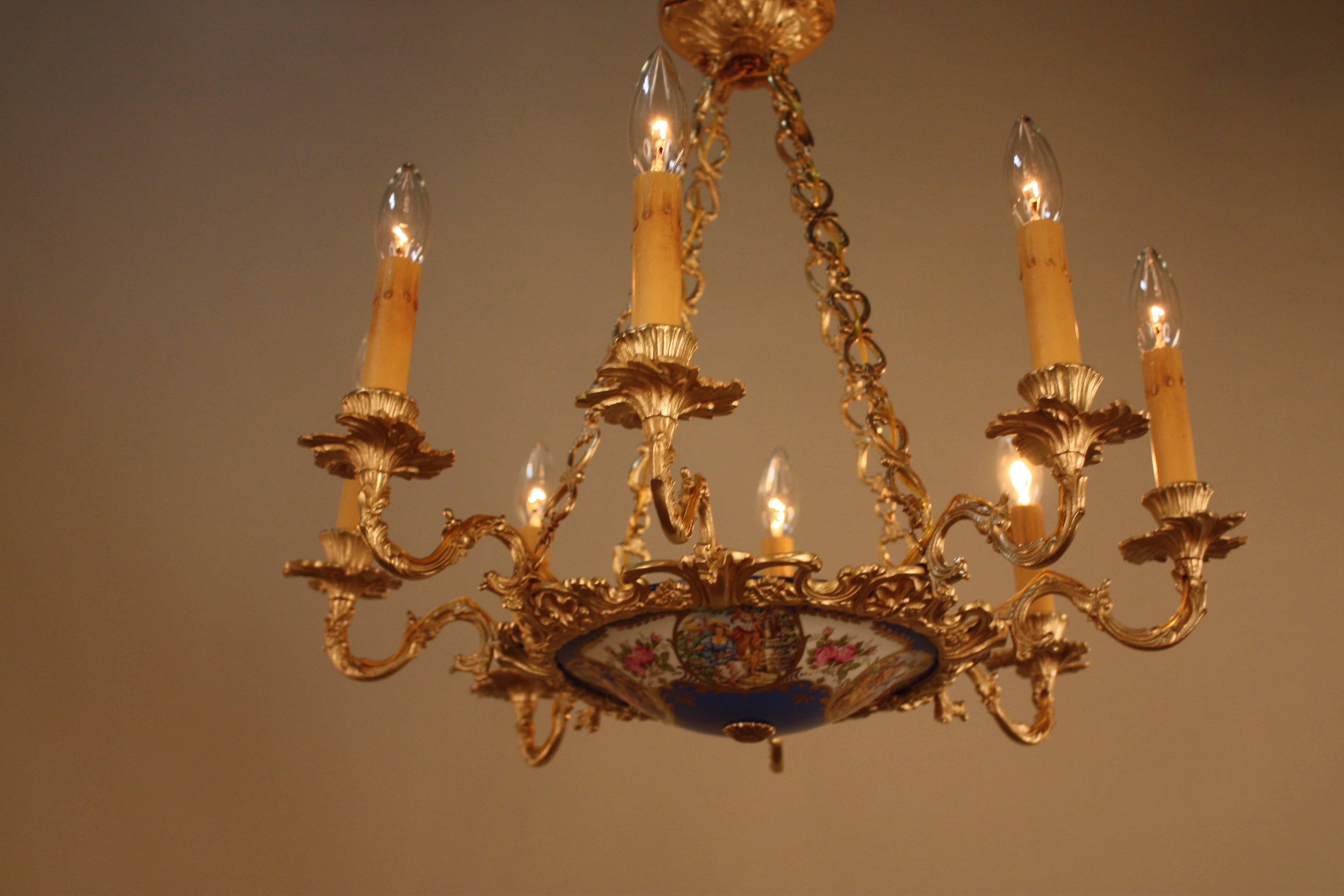Elegant eight arms bronze with Serves style center porcelain dish chandelier.