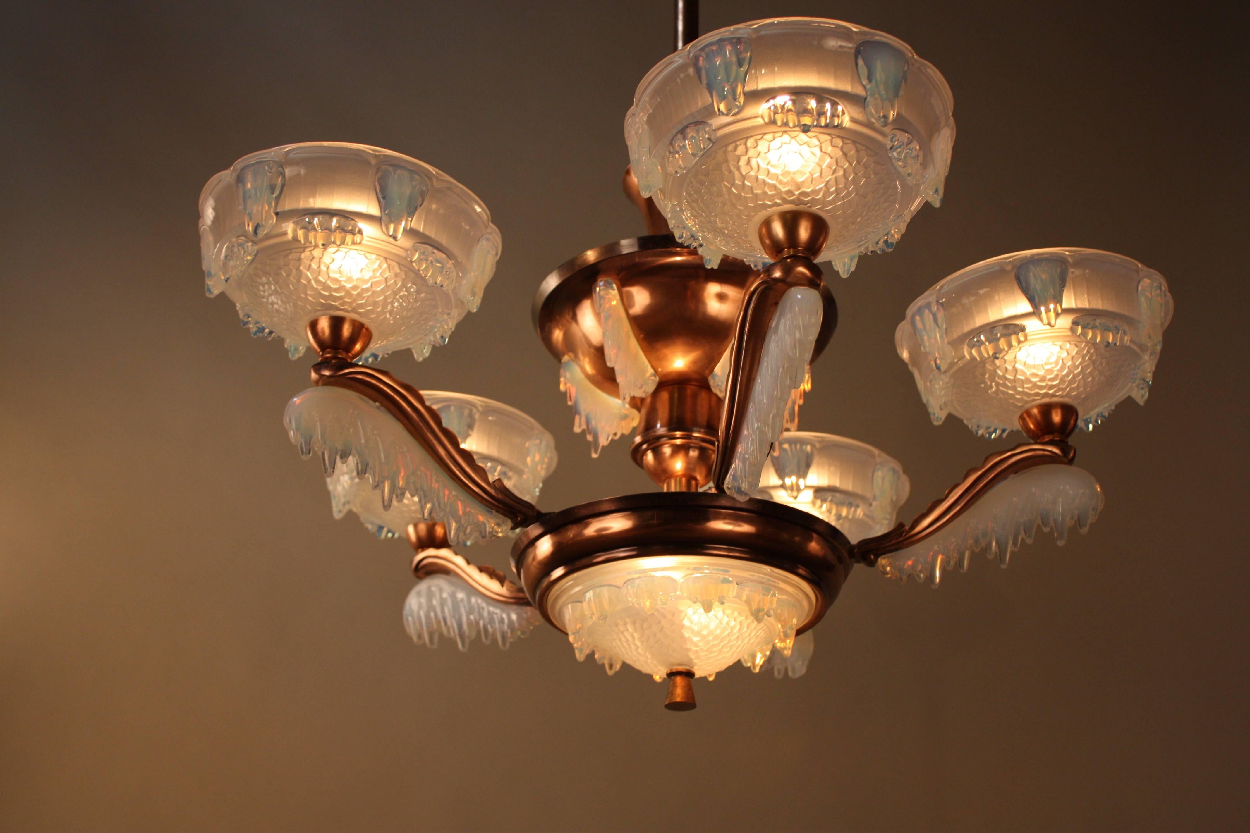 Art Deco chandelier with opalescent glass and copper plate on bronze frame by Ezan.
Total of nine lights 60watts each.