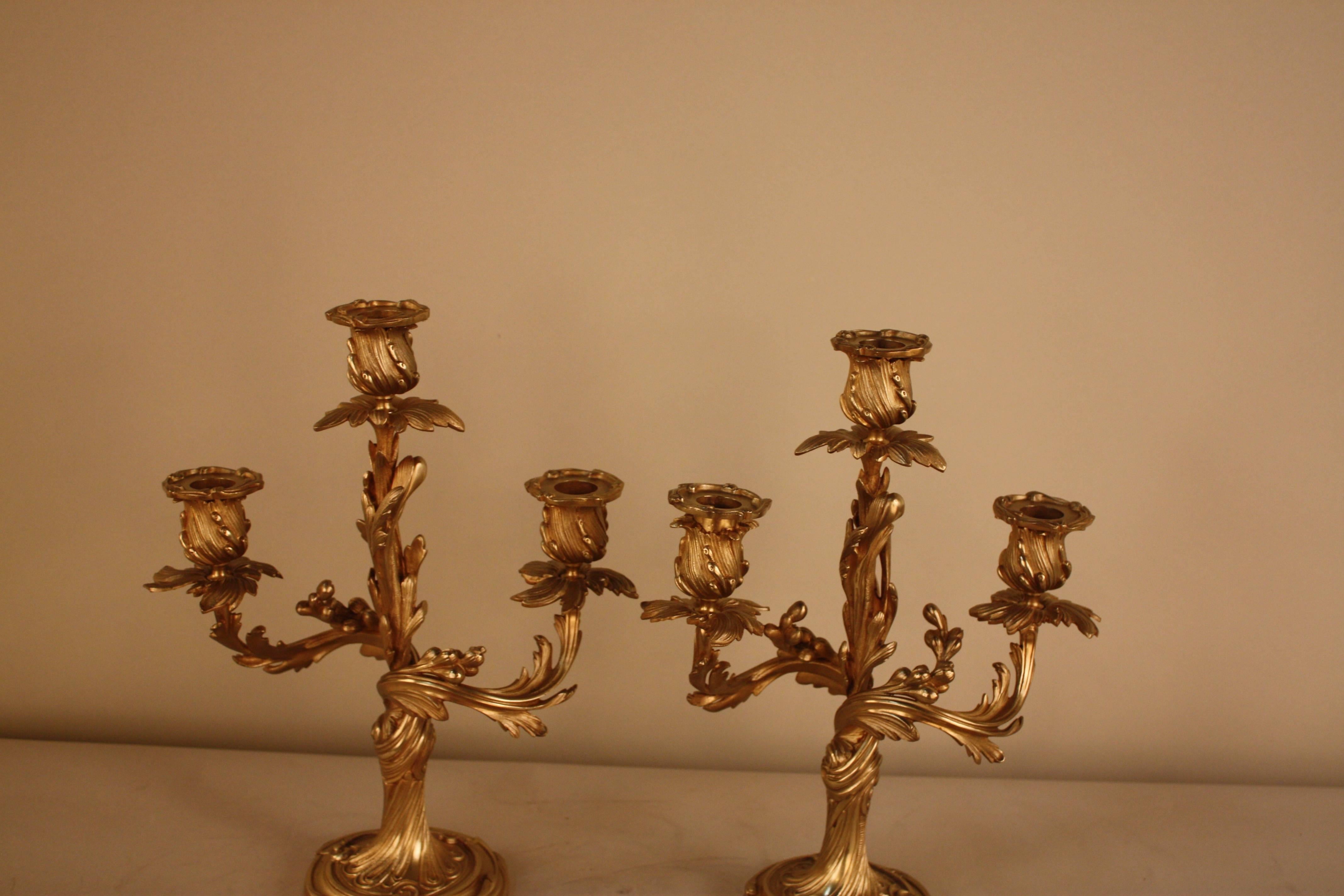 Pair of antique French bronze candelabra. Pieces have two arms, three candle cups with floral scrolled in Art Nouveau design.