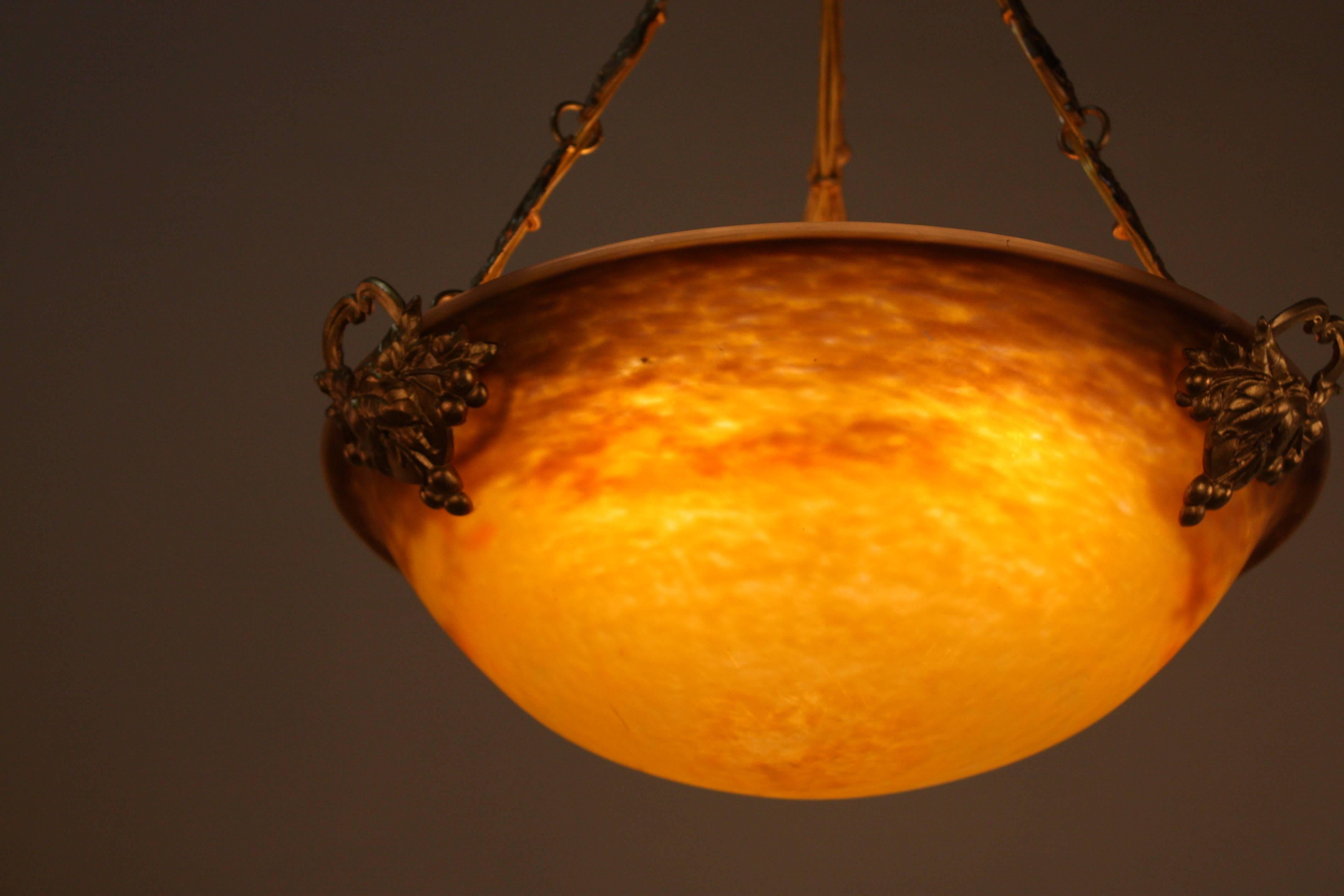 French, 1920s sunny yellow with orange and brown color handblown glass pendant chandelier with elegant bronze hardware.
Total of six-light, 60watts each.