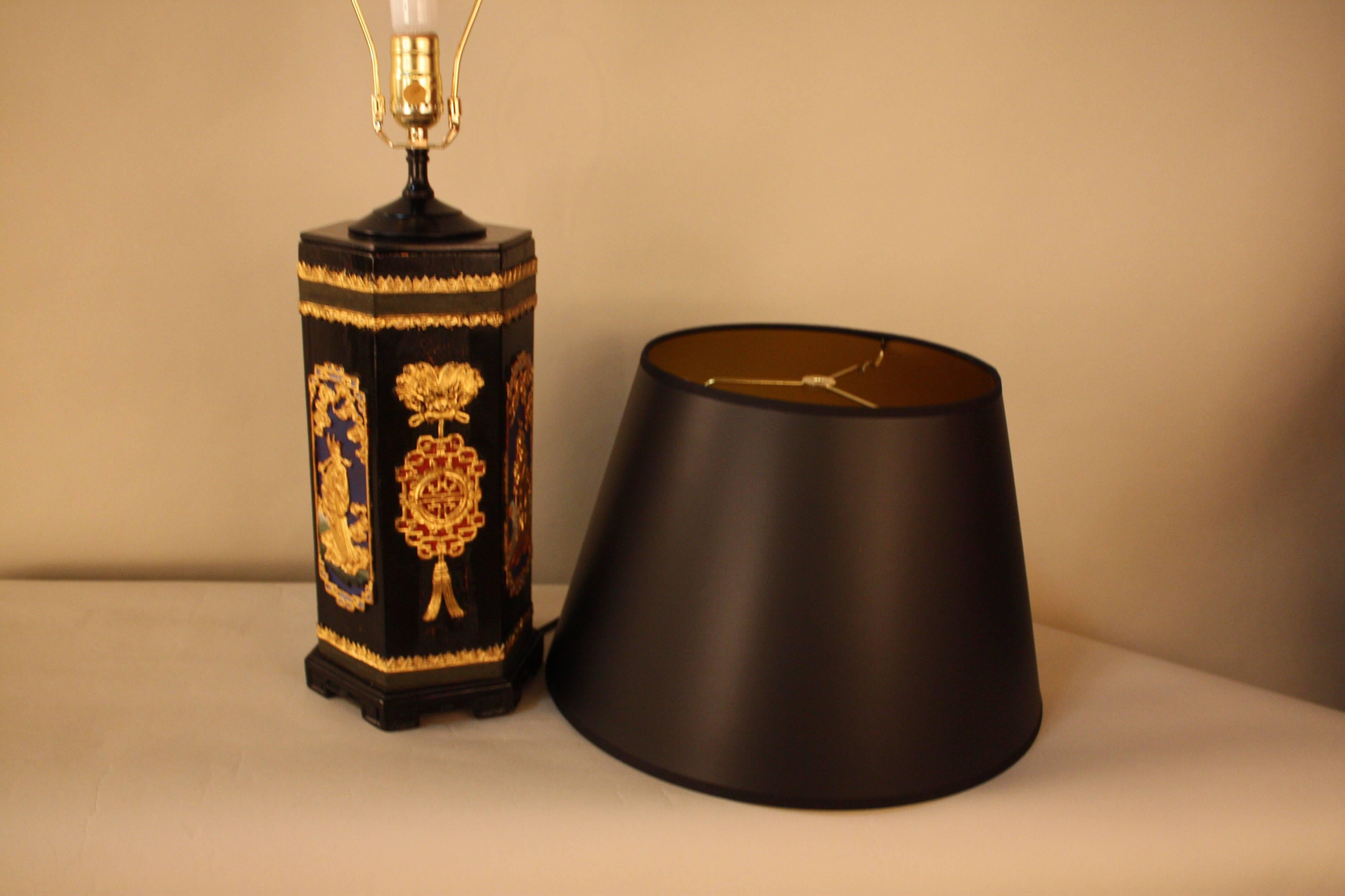 Carved gold leaf on black lacquer wood brush holder that has been customized to a table lamp.