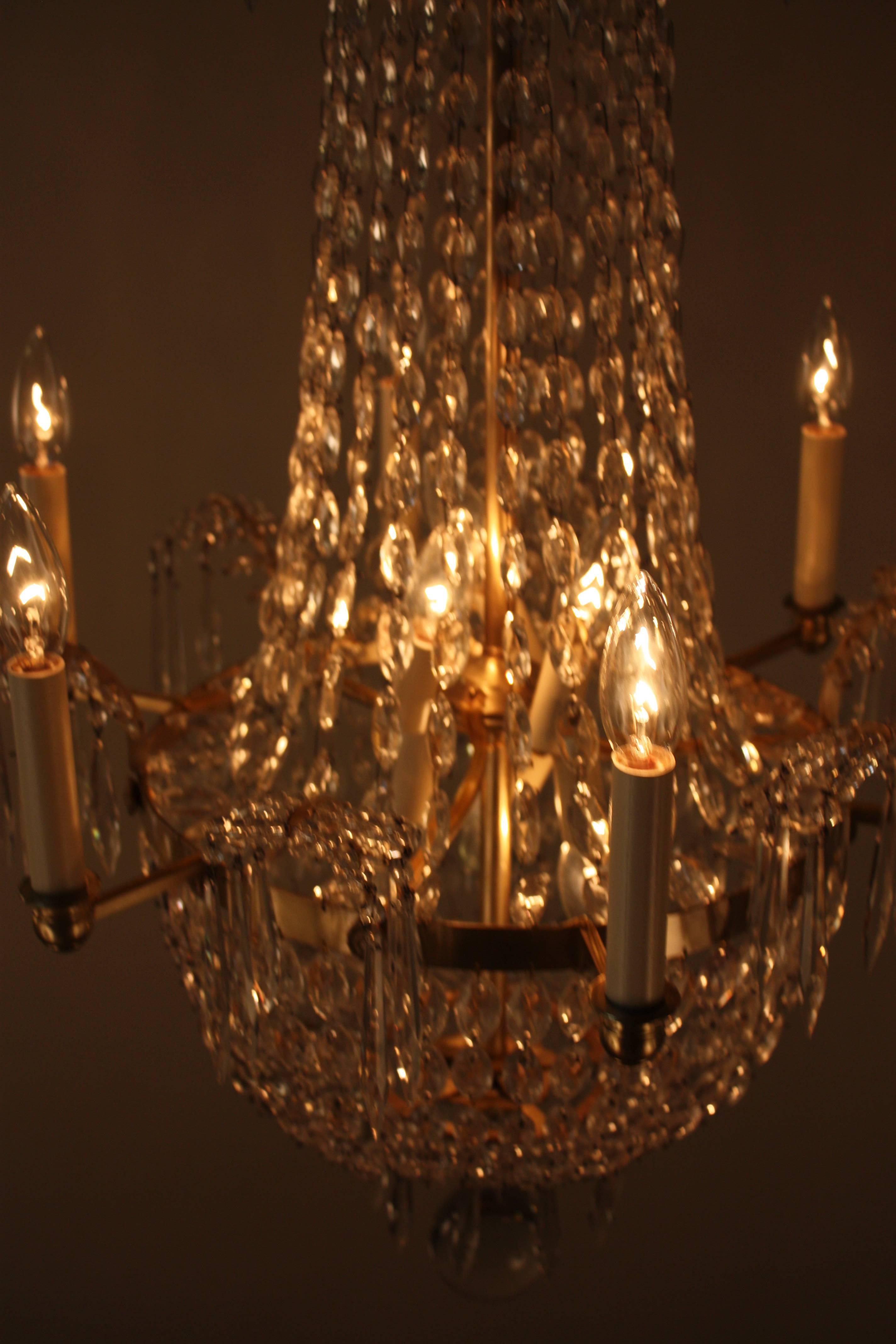 Electrified late 19th century crystal candle burning chandelier.
Six arm 12 lights 60watts each.
Minimum height with two links of chain fully installed is 36