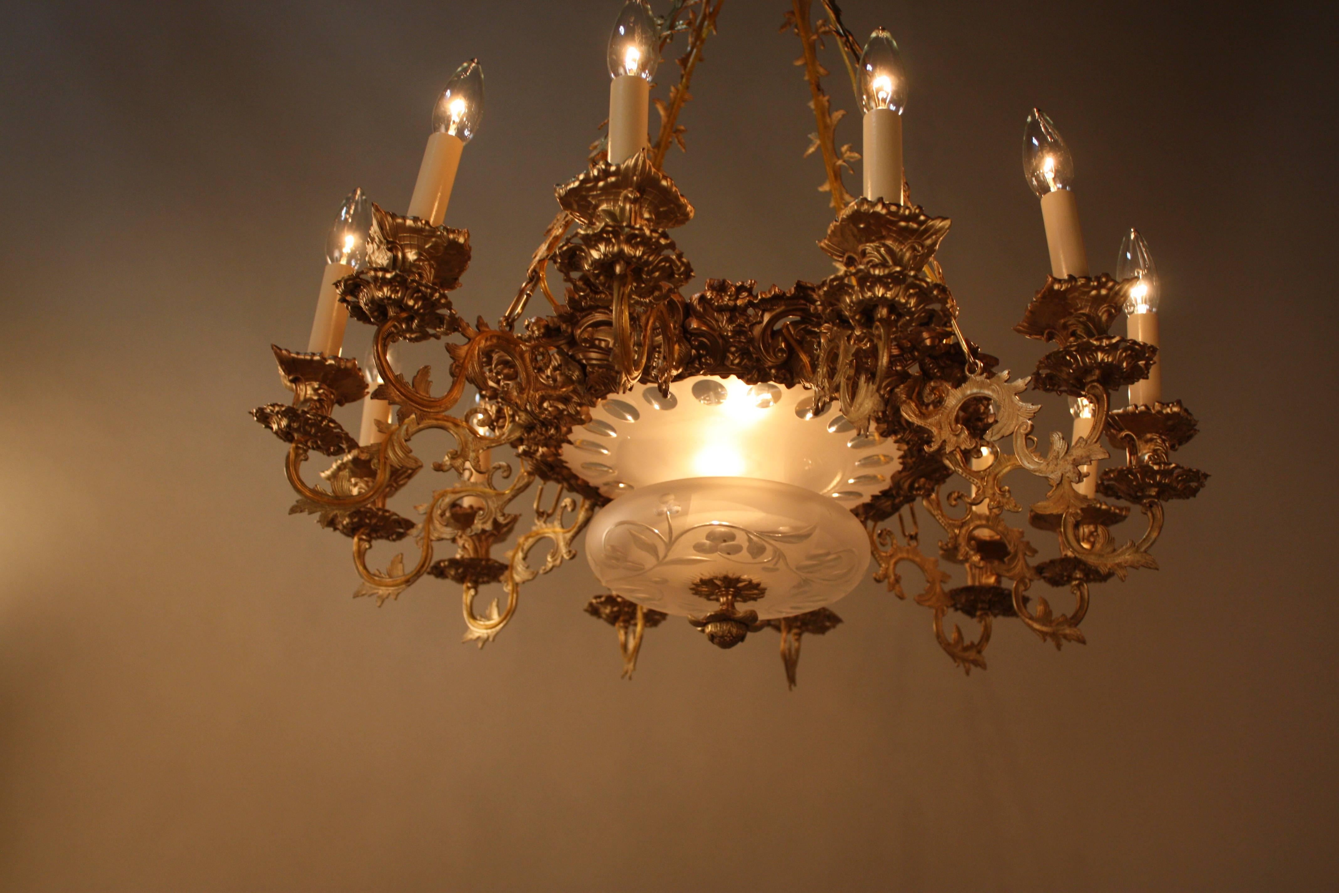19th century twelve-arm with fourteen lights electrified bronze chandelier with the cut-glass centrepiece.