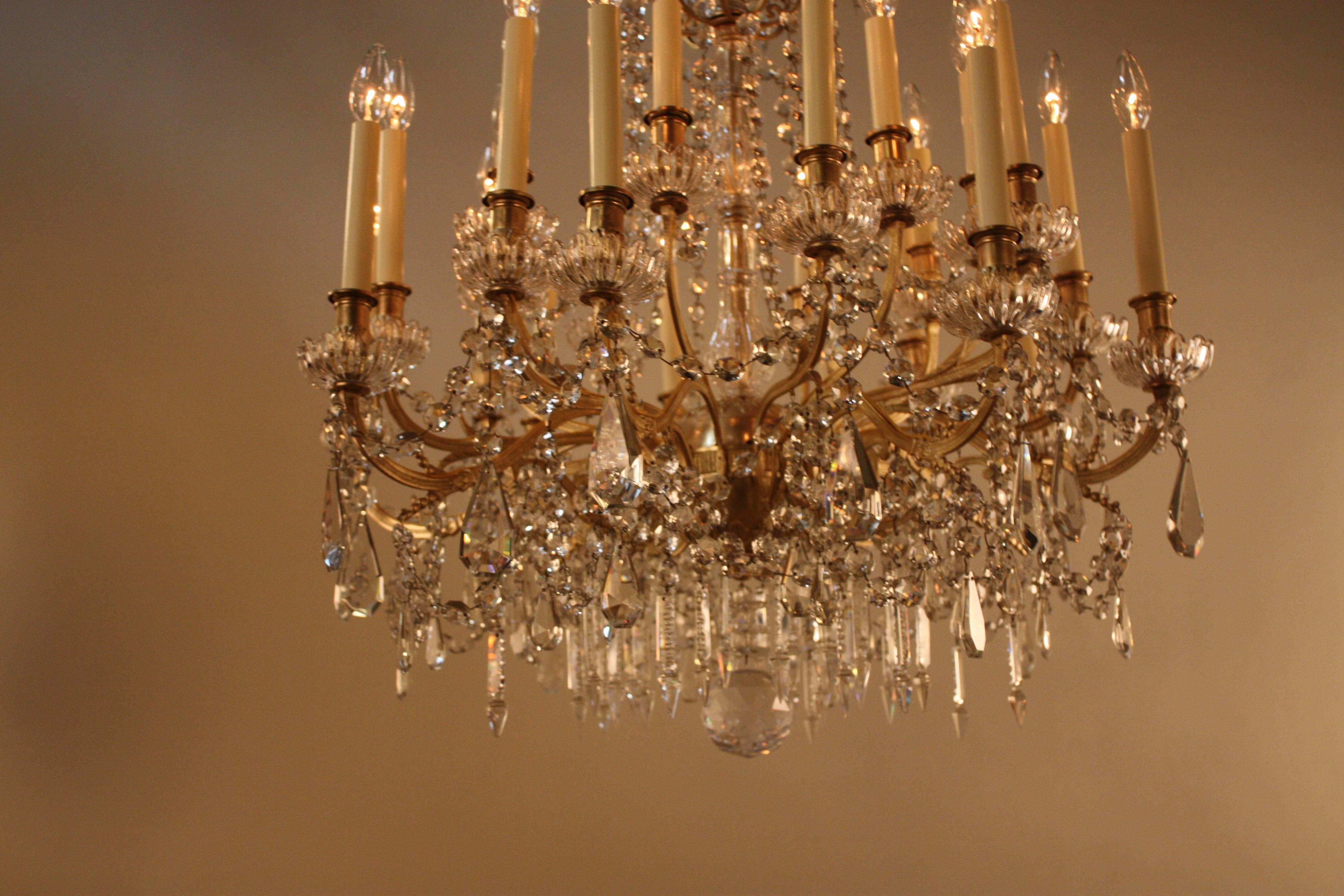 A magnificent 19th century Baccarat crystal chandelier with 24 lights and beautiful bronze work, this chandelier is the definition of elegance. 
This chandelier is 32