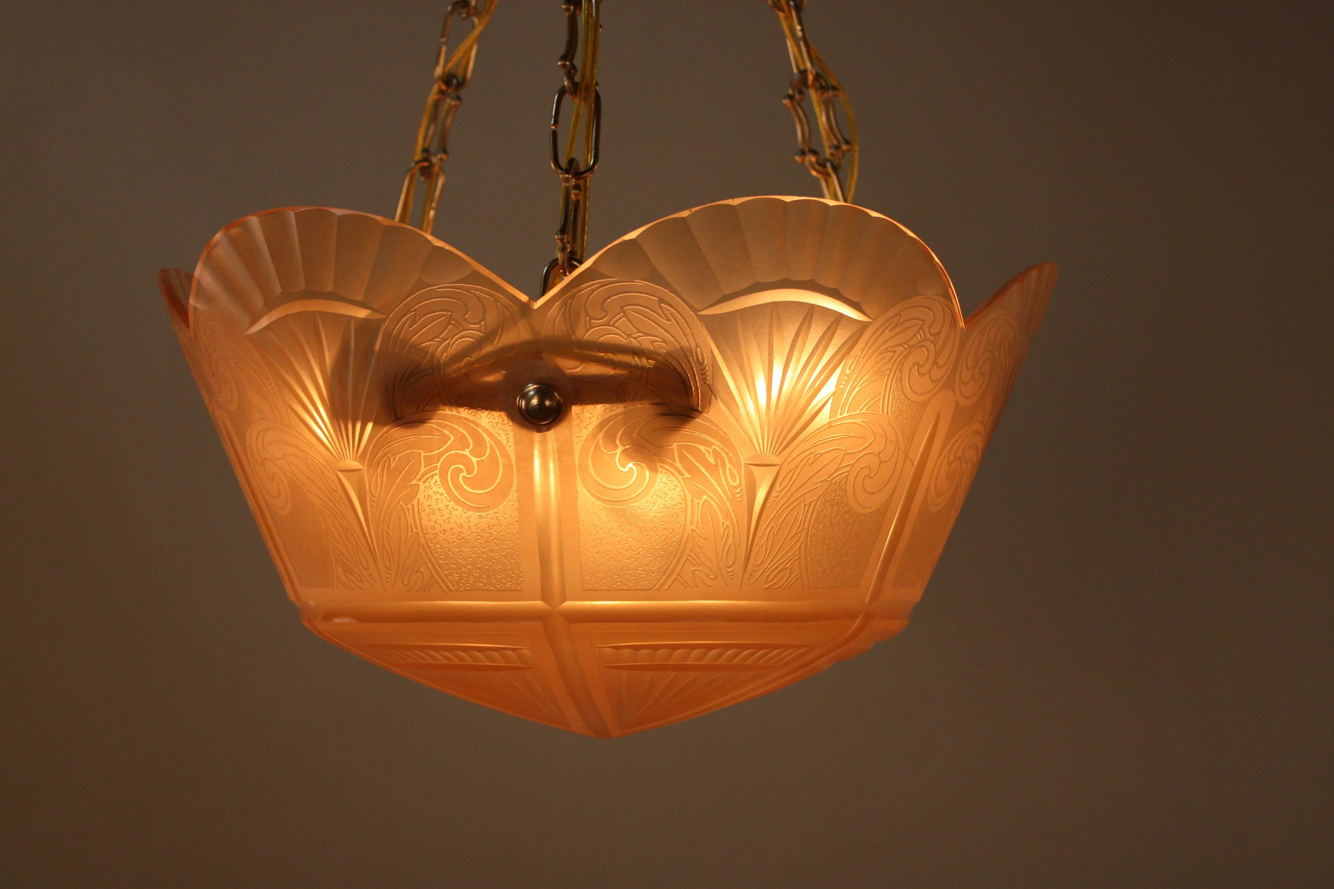 Combination of etched and cut-glass in peach color chandelier with bronze hardware.
Six lights, 60watts each.