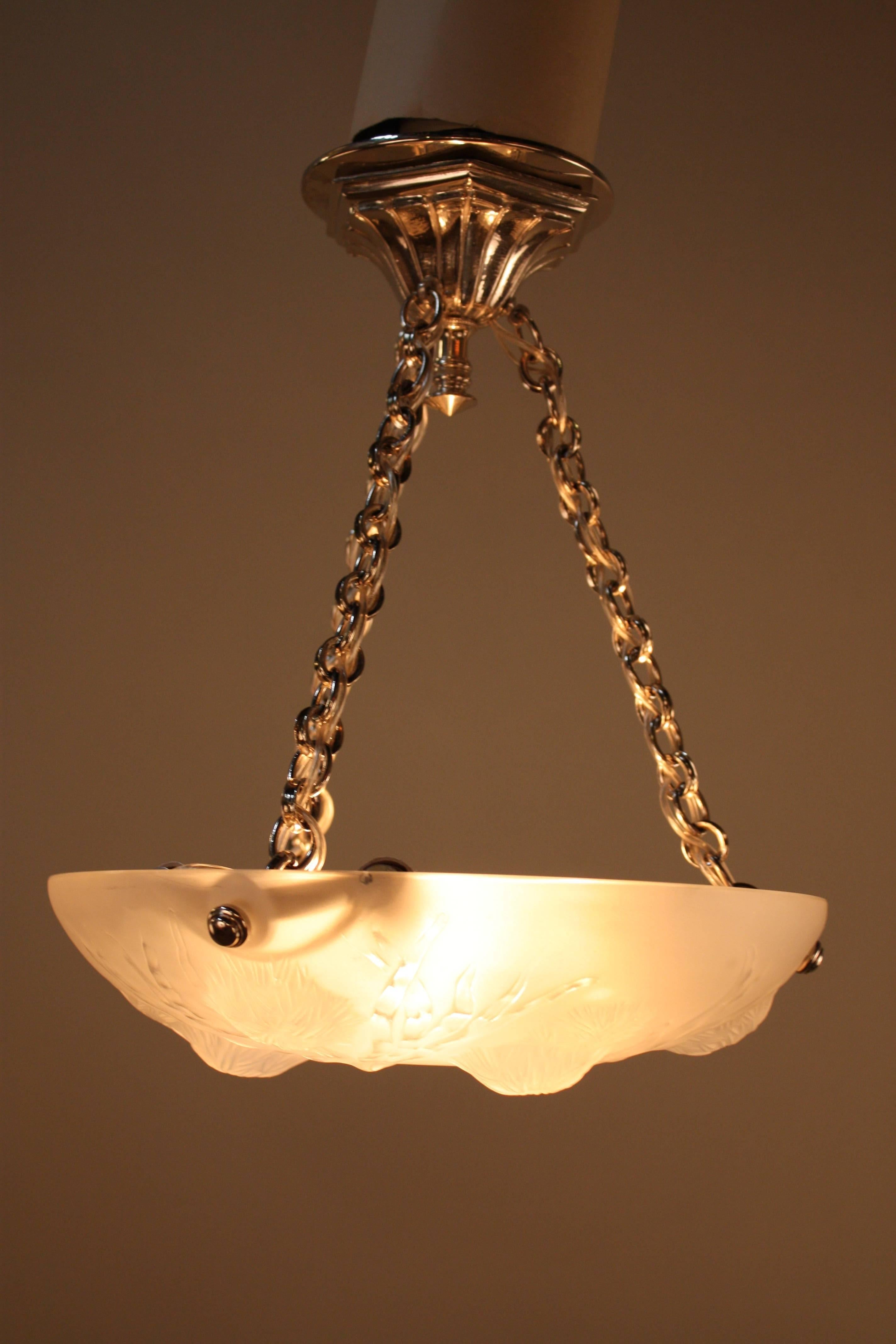 A fabulous petite Art Deco chandelier in satin glass with clear high light suspended with nickel hardware.
Six-light 60watt max each.