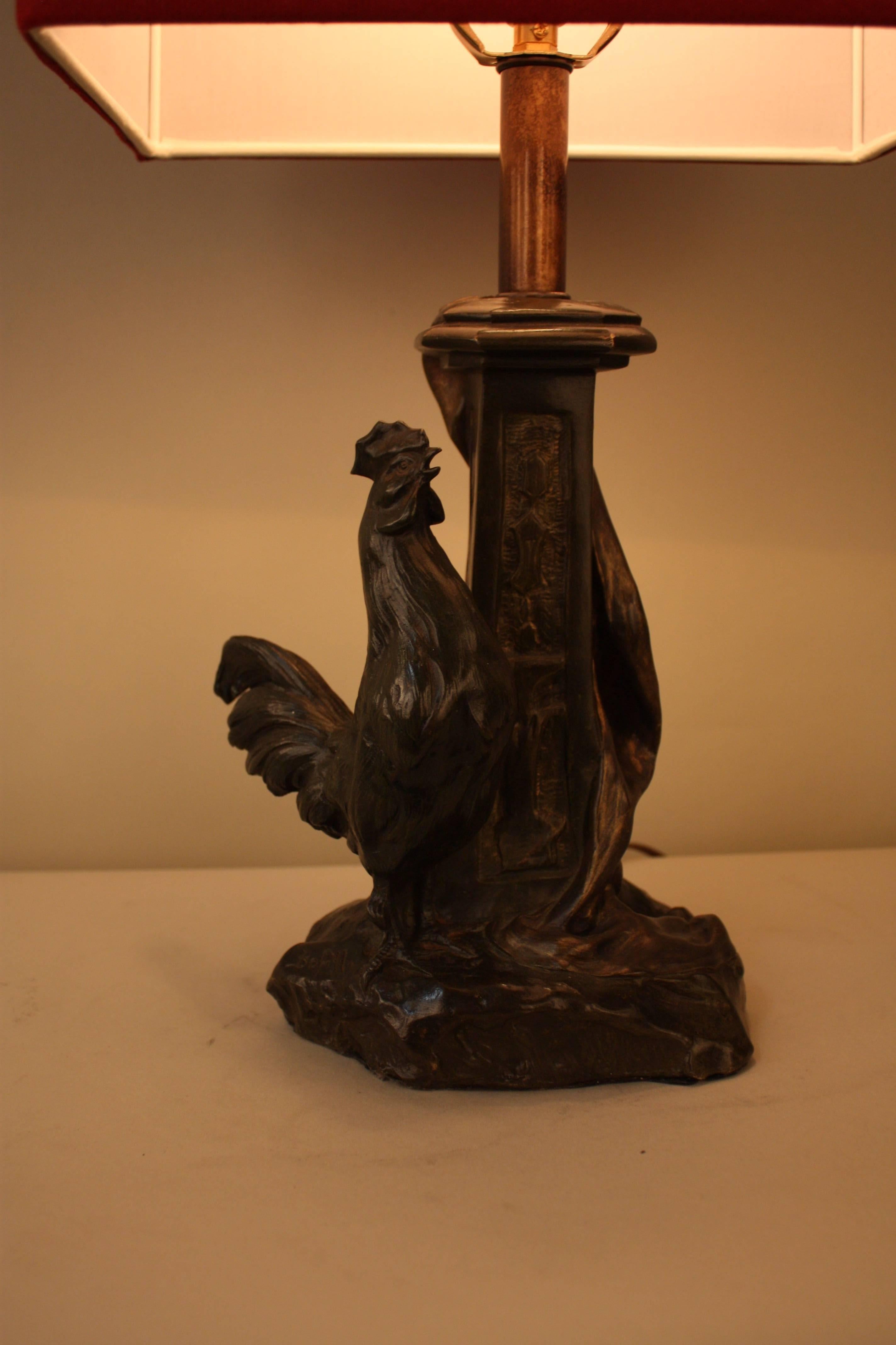 Spanish bronze rooster standing next to a column that has been customized to a table lamp.
