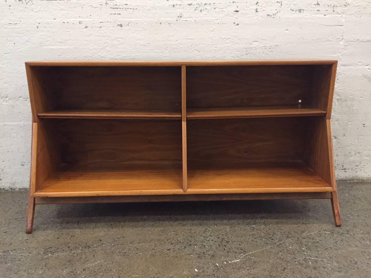 Open bookcase for Drexel by Stewart McDougall and Kipp Stewart. Item is walnut with sculptural sides. Has adjustable shelves.
The depth of the bottom is 17.5