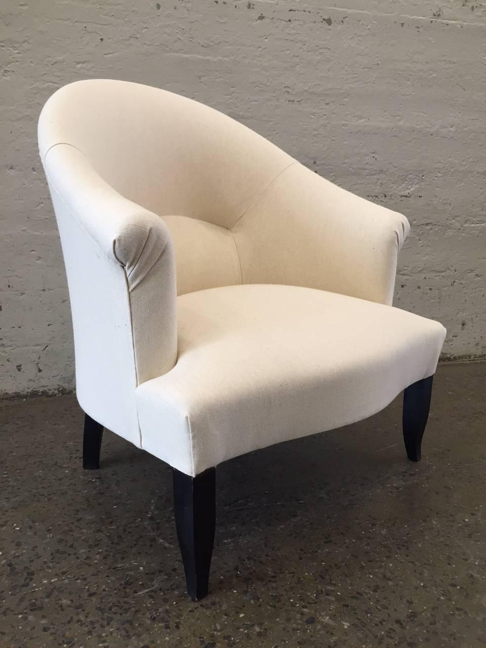 Pair of French country slipper chairs upholstered in linen-blend with black lacquered legs.