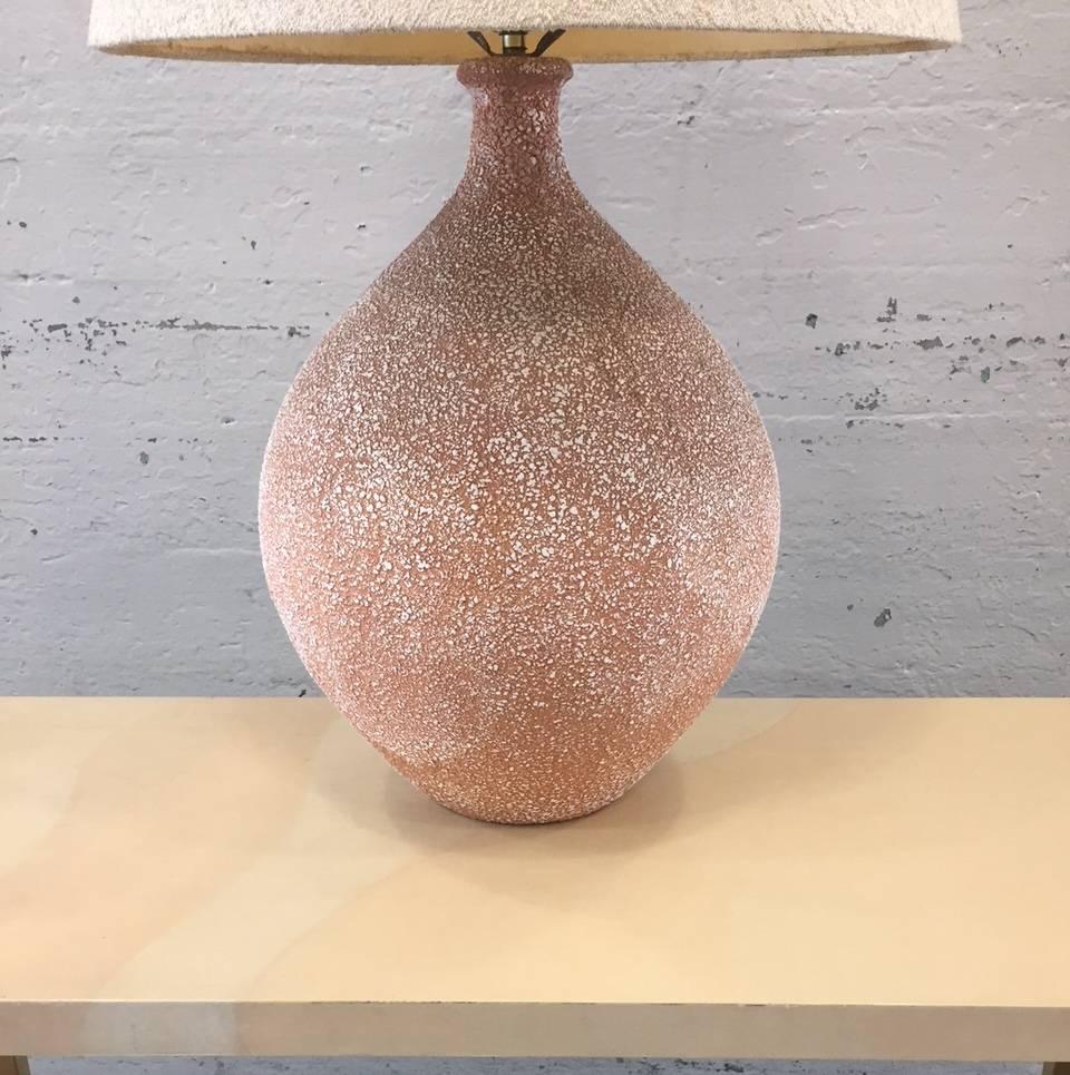Pair of textured ceramic lamps.
Measures: 31.5" H (to top of finial) 20.5" H (under socket) width: 14" (at it's widest). Shades not included.