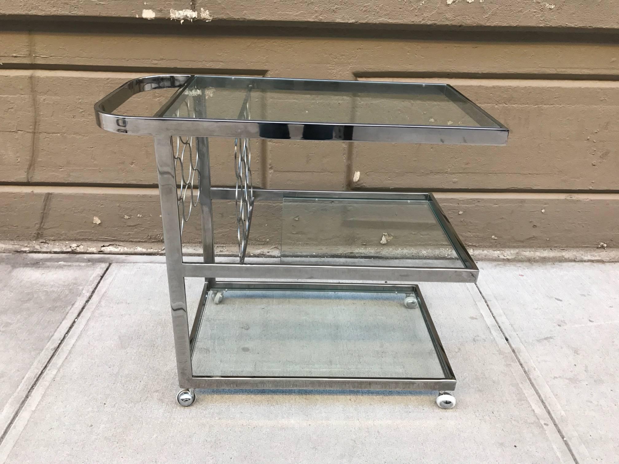 Chrome bar or serving cart with three glass shelves and individual bottle holders.