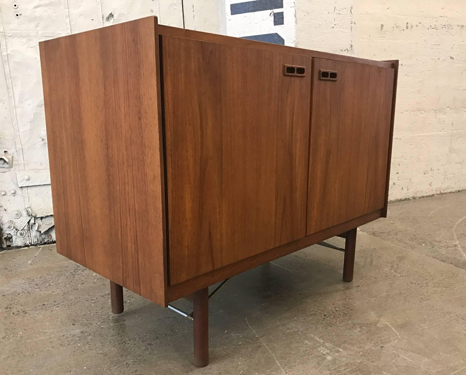 Danish Mid-Century Modern teak cabinet by Kurt Ostervig. Has four sliding drawers, removable shelves and a finished back.