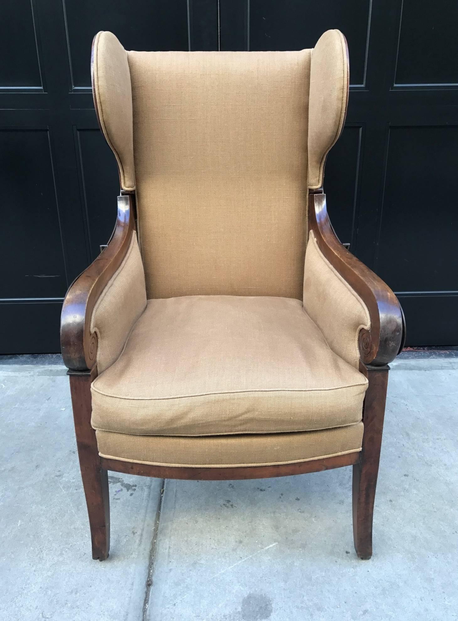 Antique, Biedermeier reclining wingback chair with a walnut frame. Has a down cushioned seat and casters. Reclining, iron, mechanism is in working order.
