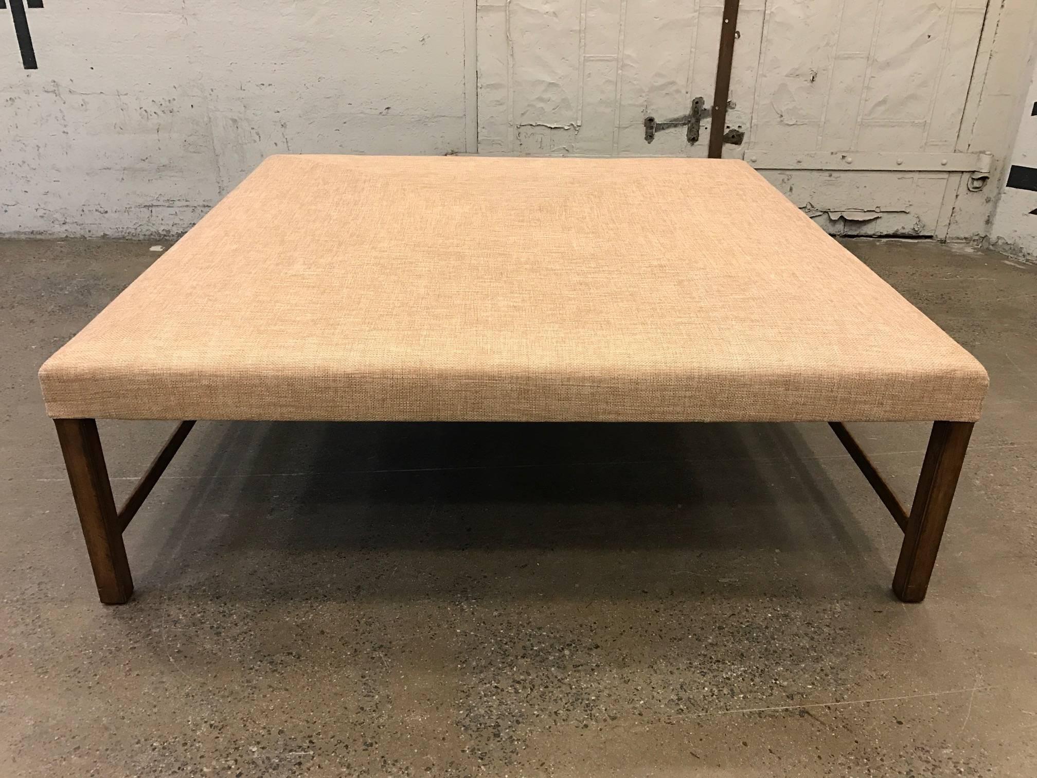 Can easily be used as a large bench or add a glass top to make a coffee table. Has walnut base. Newly upholstered in linen blend fabric.