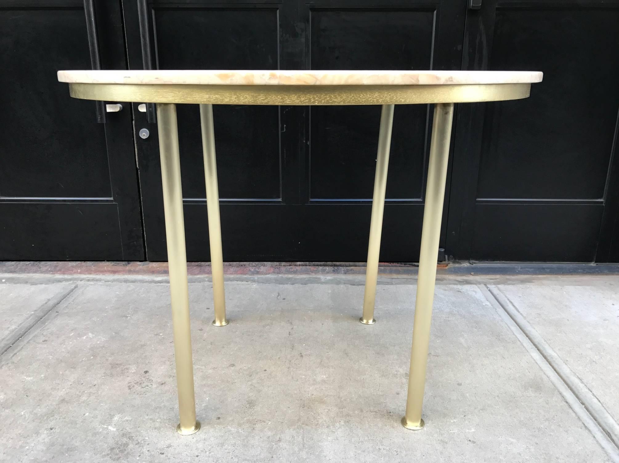 Marble-top center or dining table with tubular brass legs. Style of Raphael.