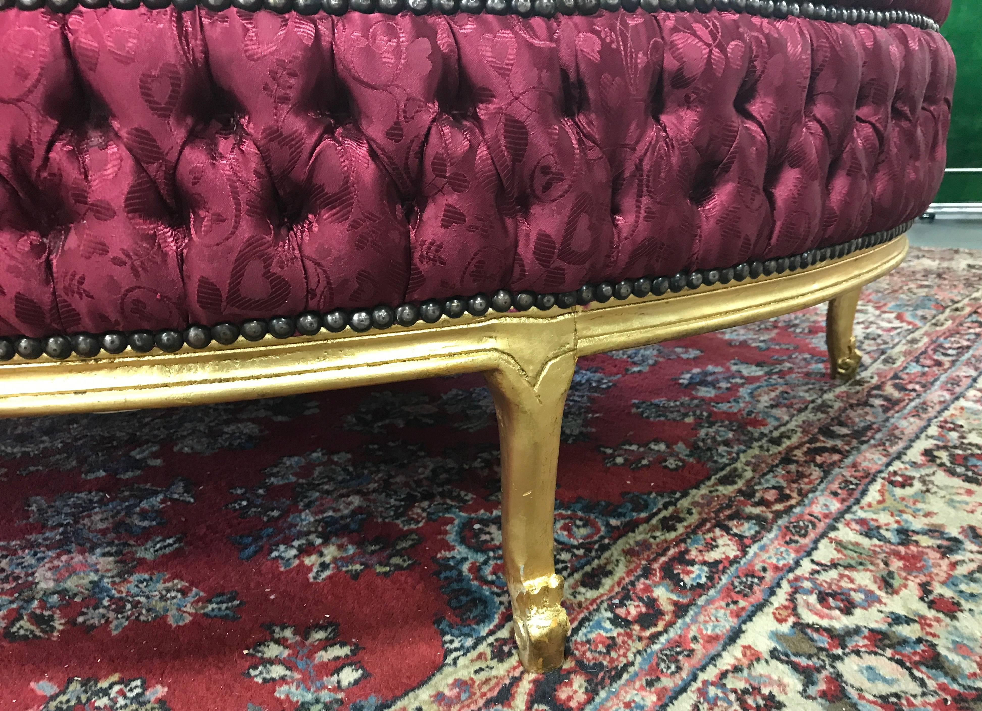 Five feet round Louis XIV style tufted ottoman. Has a wooden, gold painted base.