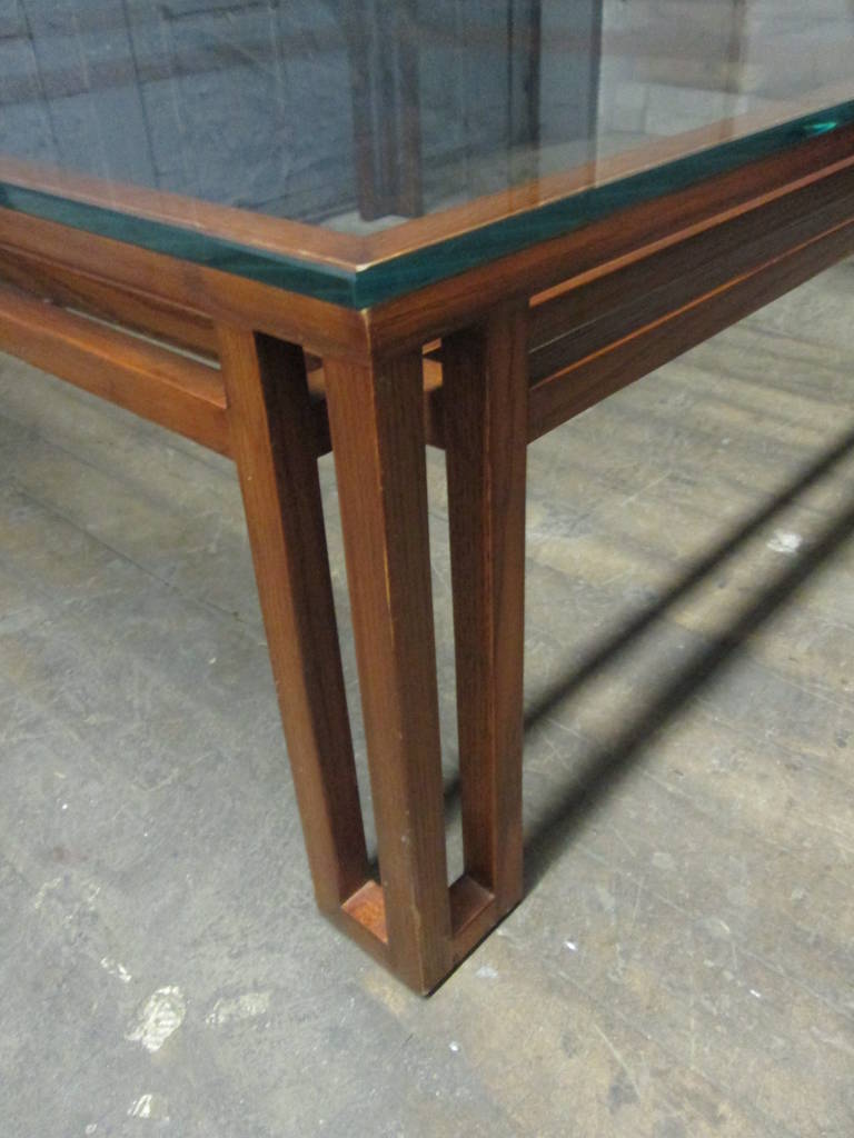 Danish Mid-Century Modern coffee table. Glass top rests on base.
