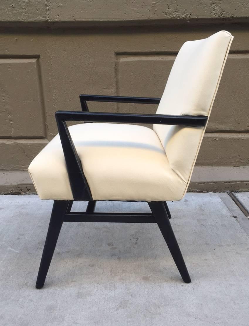 Pair of Jens Risom armchairs with black lacquered wood frames.
  