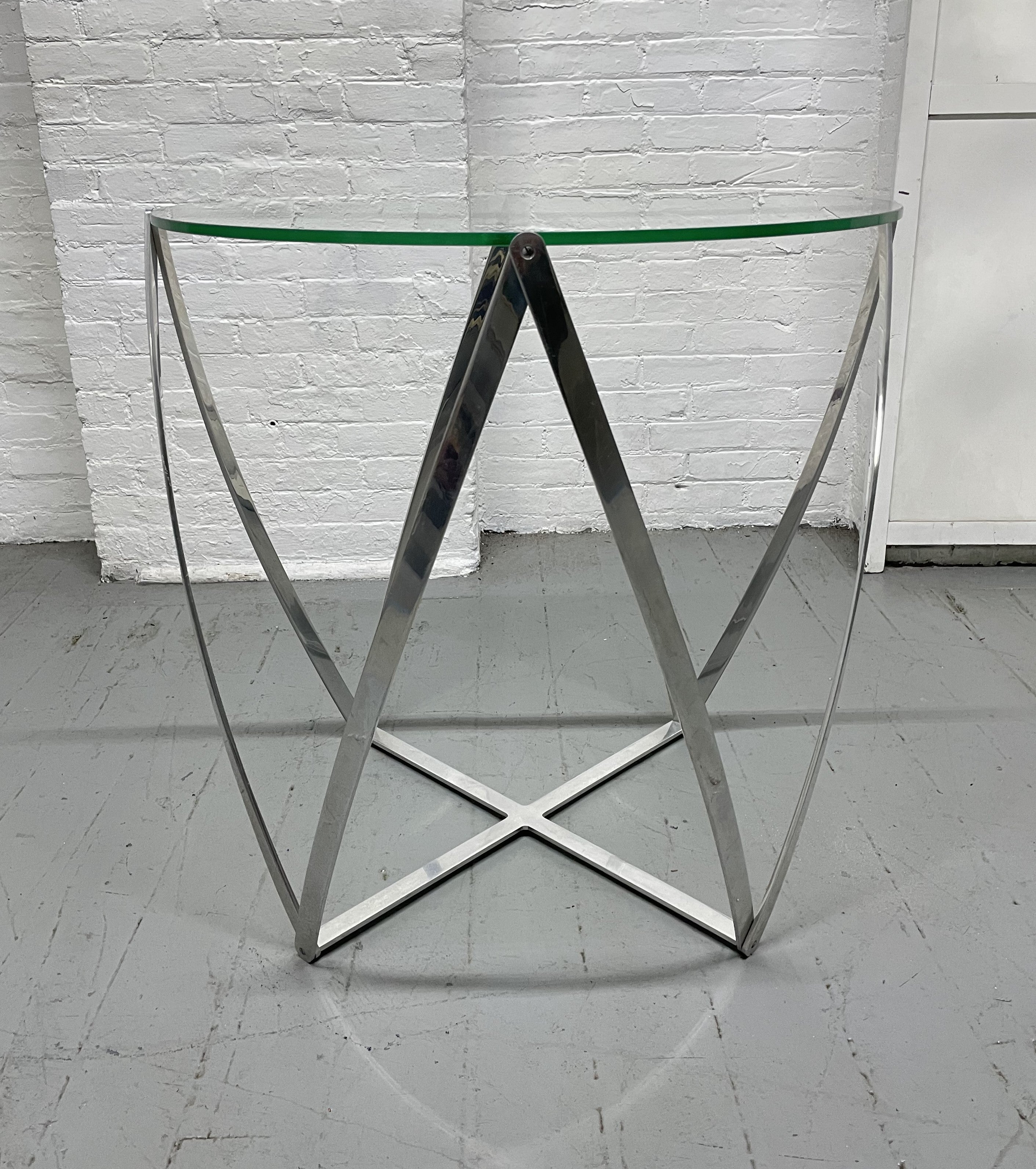 John Vesey Aluminum and Glass Spool Side Table. Polished aluminum and glass top side table. This is the largest version of the John Vesey Spool table.
