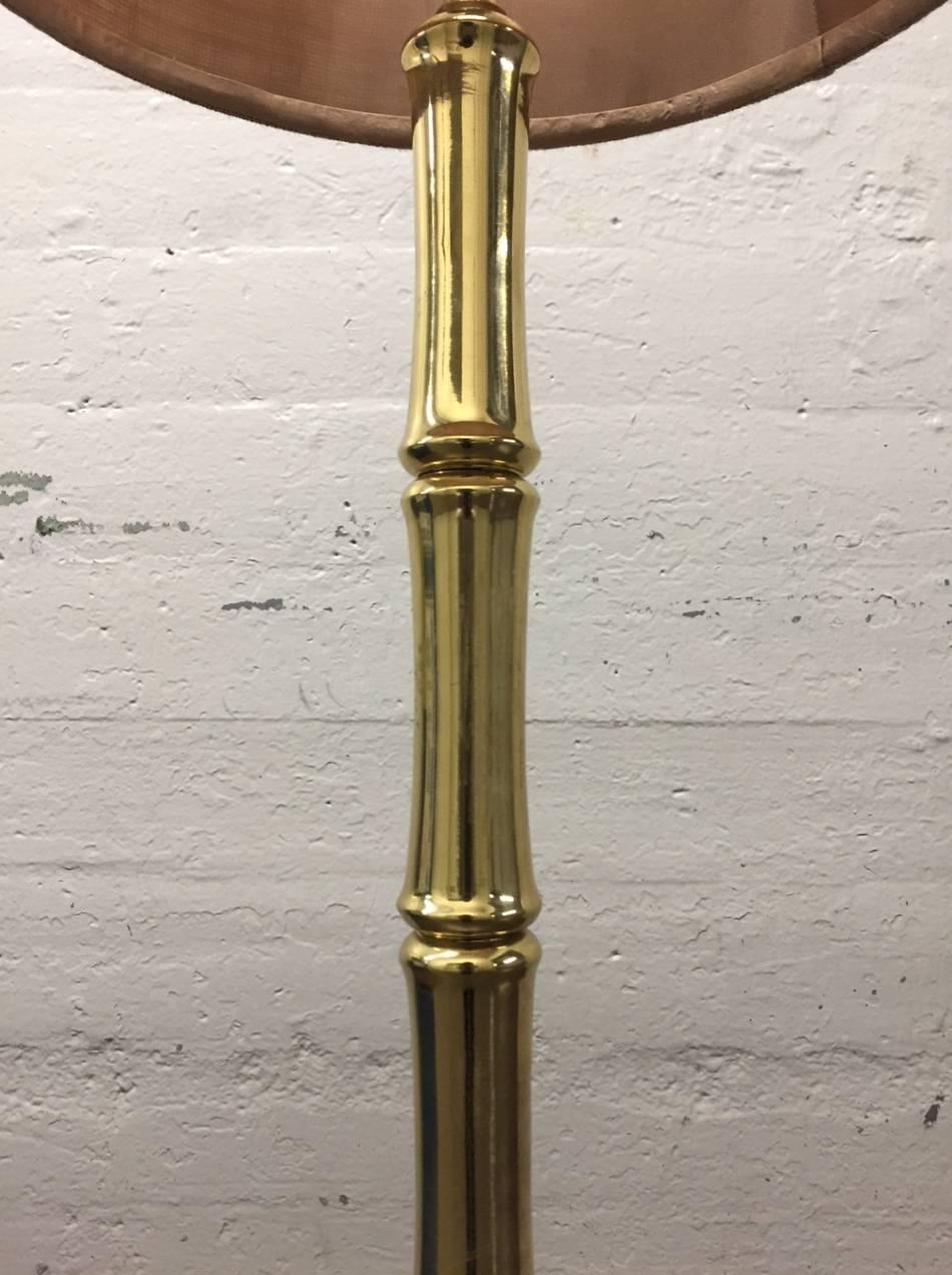 Brass faux bamboo floor lamp. Shade not included. 
Measures: 57.5" H (to top of finial) under socket 46" H. 
Body of lamp 2" in diameter. Base 9" in diameter.
