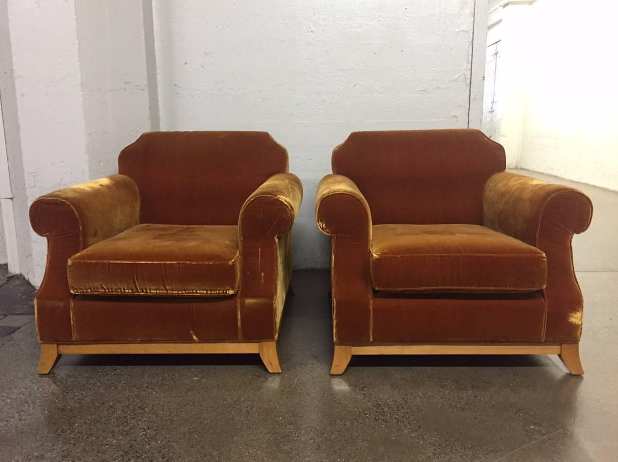 Pair of English distressed velvet lounge chairs. Has a nice solid wooden base. Club chairs 