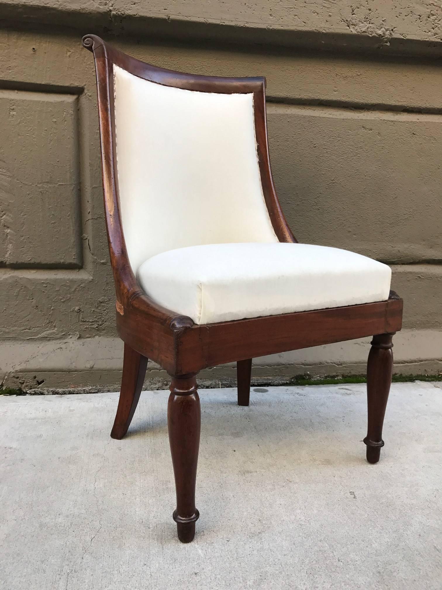 Set of four Regency style mahogany chairs. Chairs are solid mahogany, has a curved back and muslin upholstery.