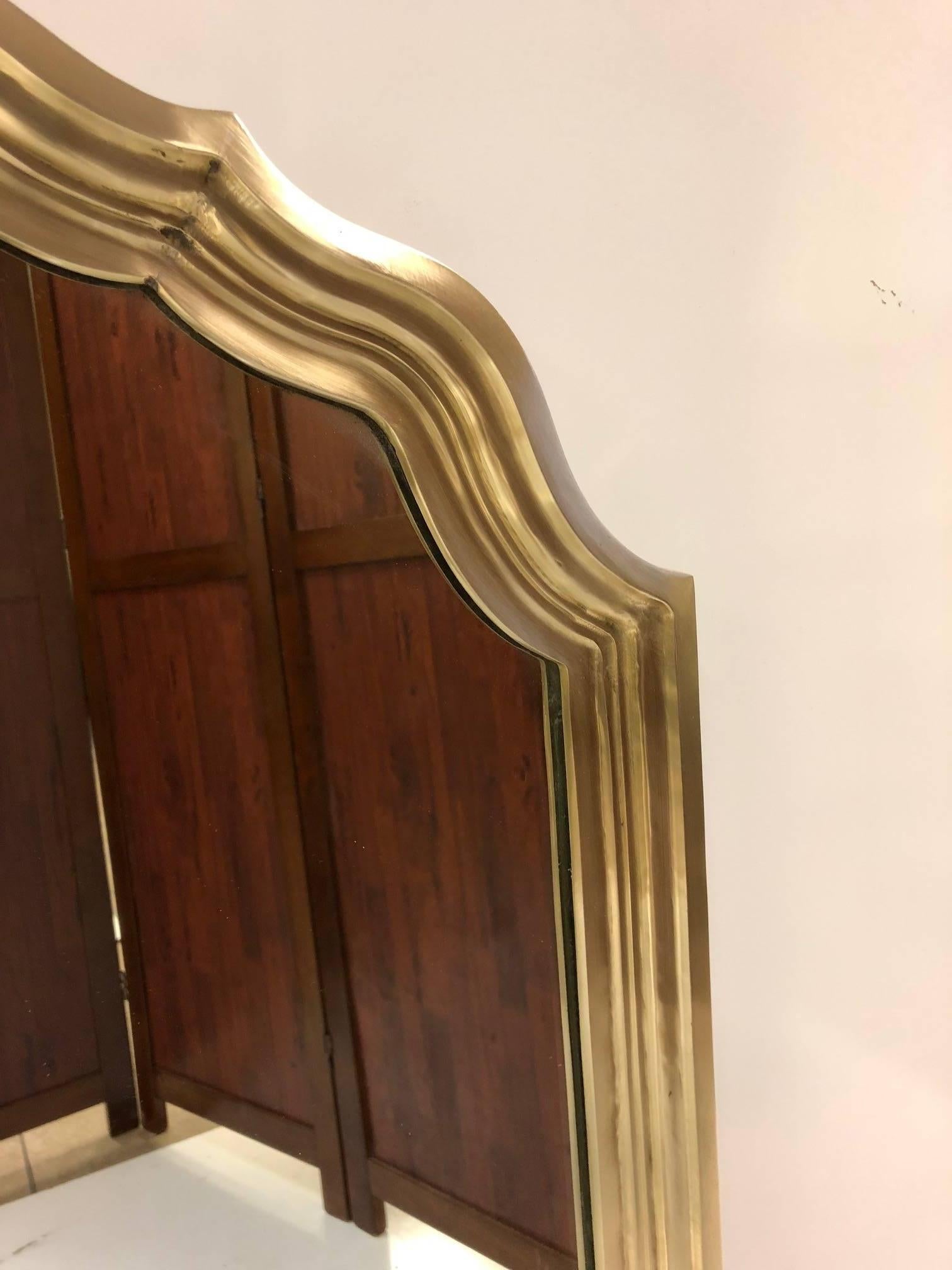 Hollywood Regency solid brass scalloped edge mirror.