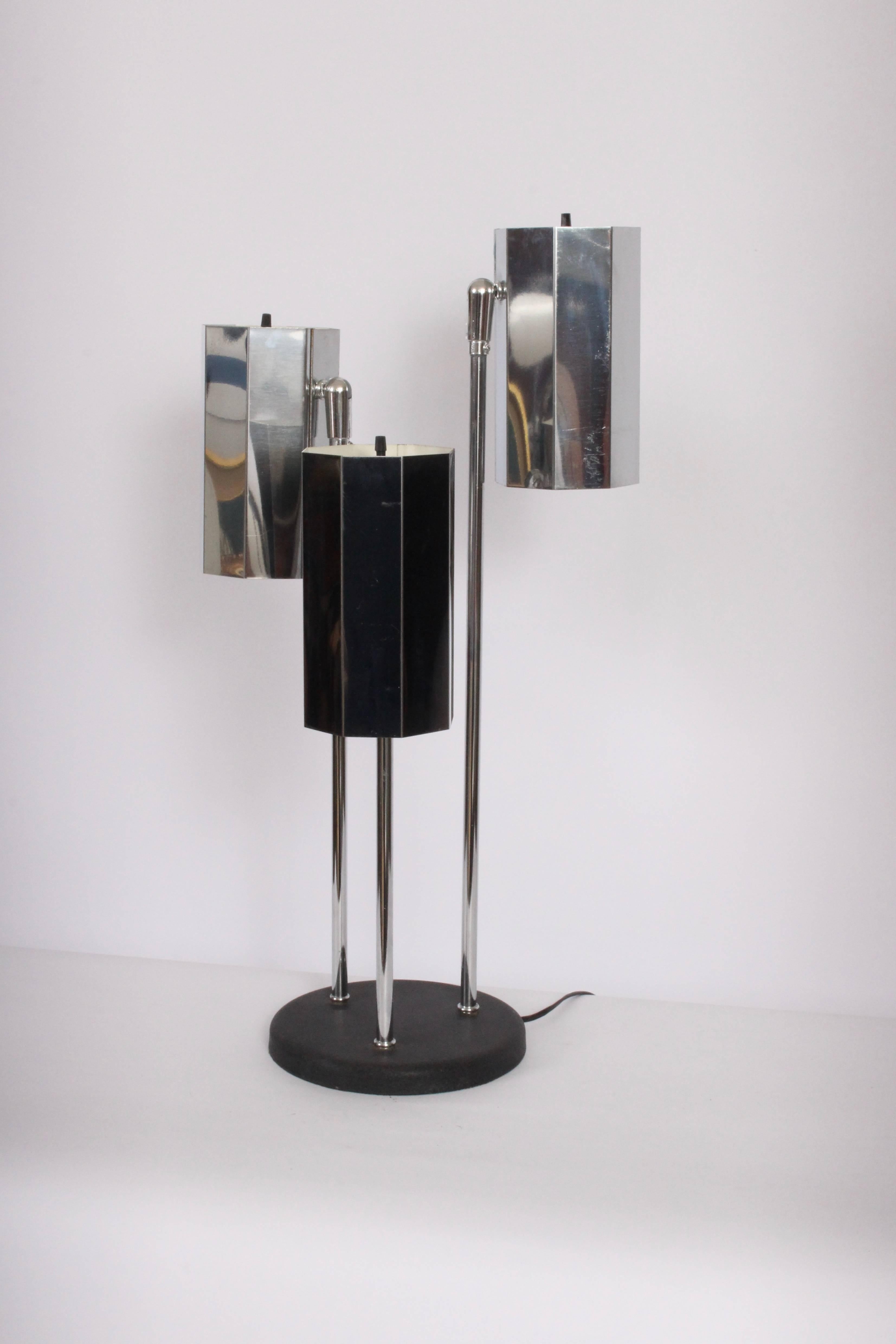 Circa 1970 trl-shade reading table lamp with reflective octagonal chrome plate shades, attributed Koch & Lowy. Featuring chrome stem, three pivoting, eight-sided chrome plate cylinder exterior shades, off-white enameled shade interior and round