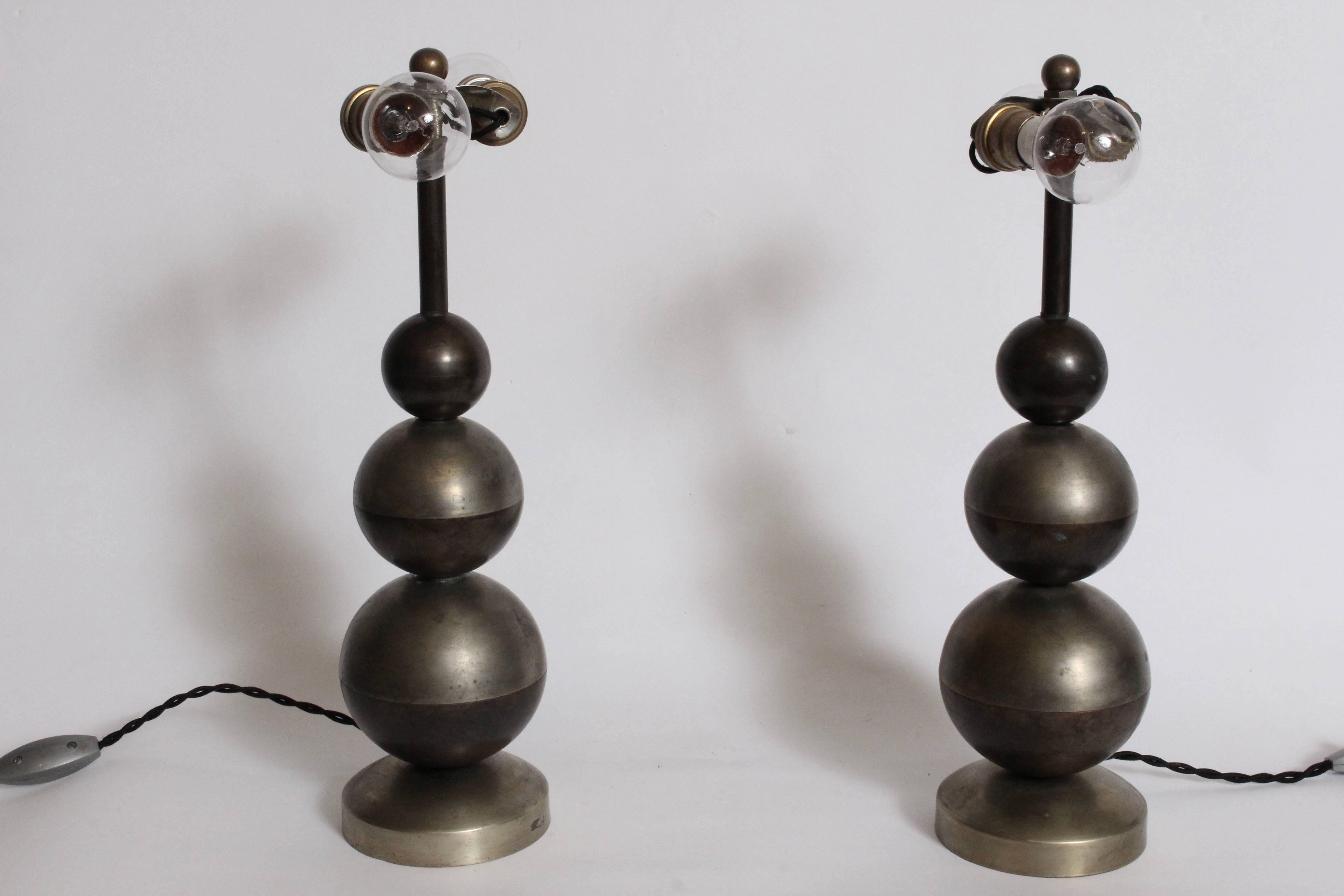 Pair of Jean Boris Lacroix style triple ball nickel-plated brass table lamps with brass shades. Featuring triple stacked ball form with top half in nickel plate and bottom half in brass. Nickel-plated spun Brass dome shade exterior with brass