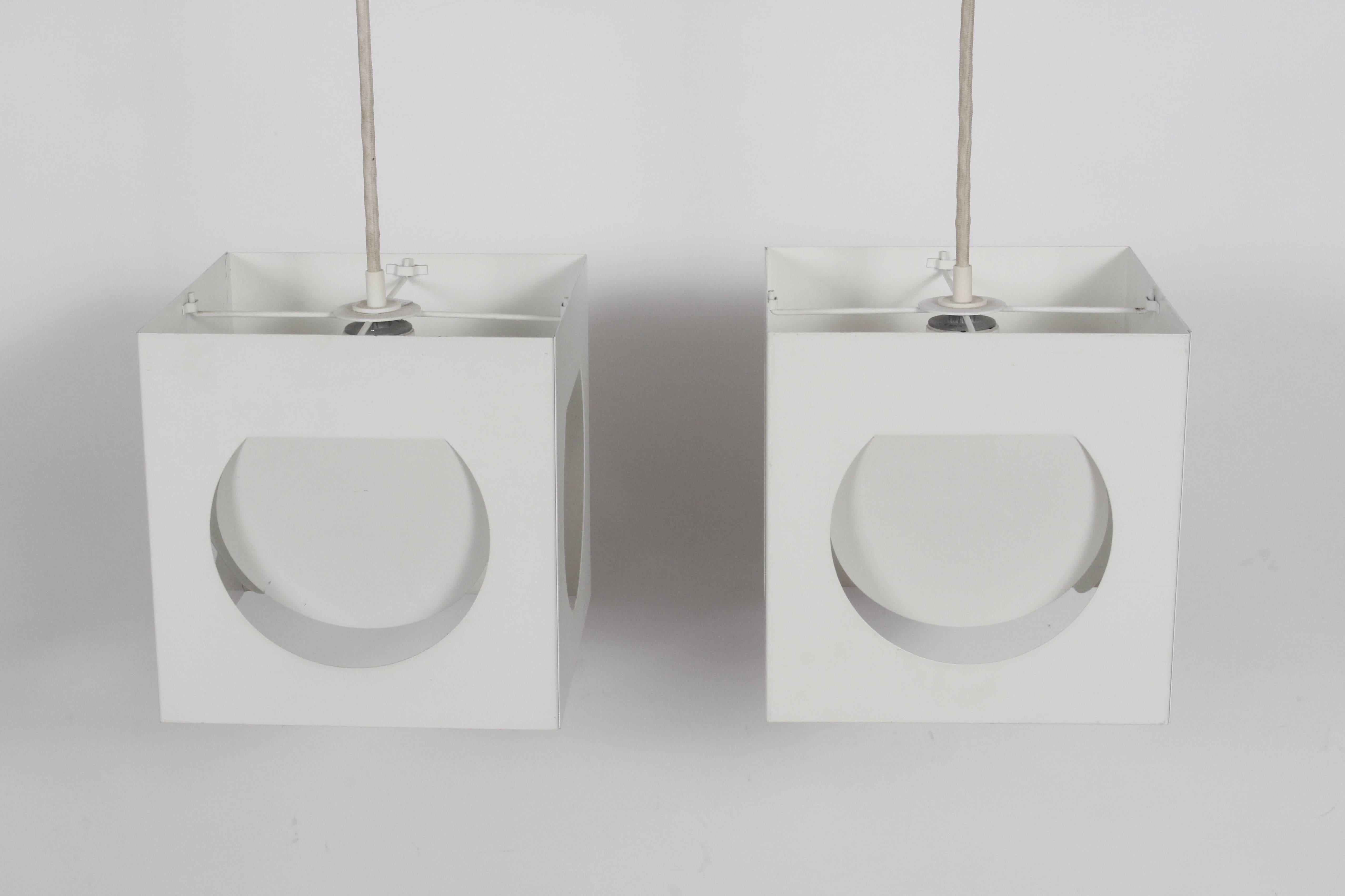 Pair of White (Model 61-193) Hanging Pendants by Shogo Suzuki for Orno Stockmann. 1960's. Featuring white coated folded metal cubes with rounded cut outs, with original coated white cord and elliptical light detail. Architectural. Minimalist.