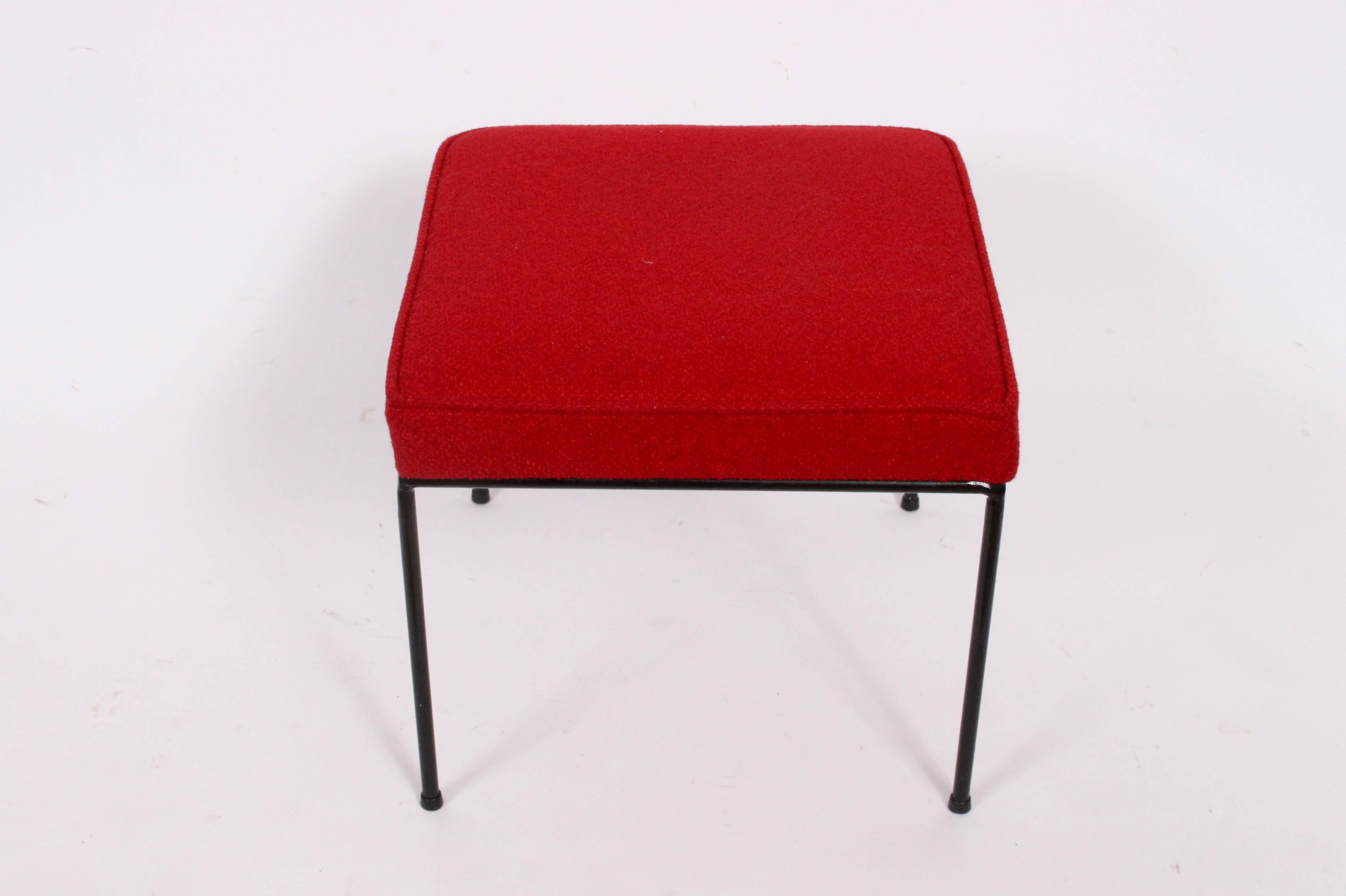American Mid-Century Modern Frederick Weinberg black wrought iron ottoman. Featuring a sturdy Wrought Iron framework and newly upholstered in bright red wool fabric and slip cover in same fabric. With protective black plastic capped feet. Versatile.