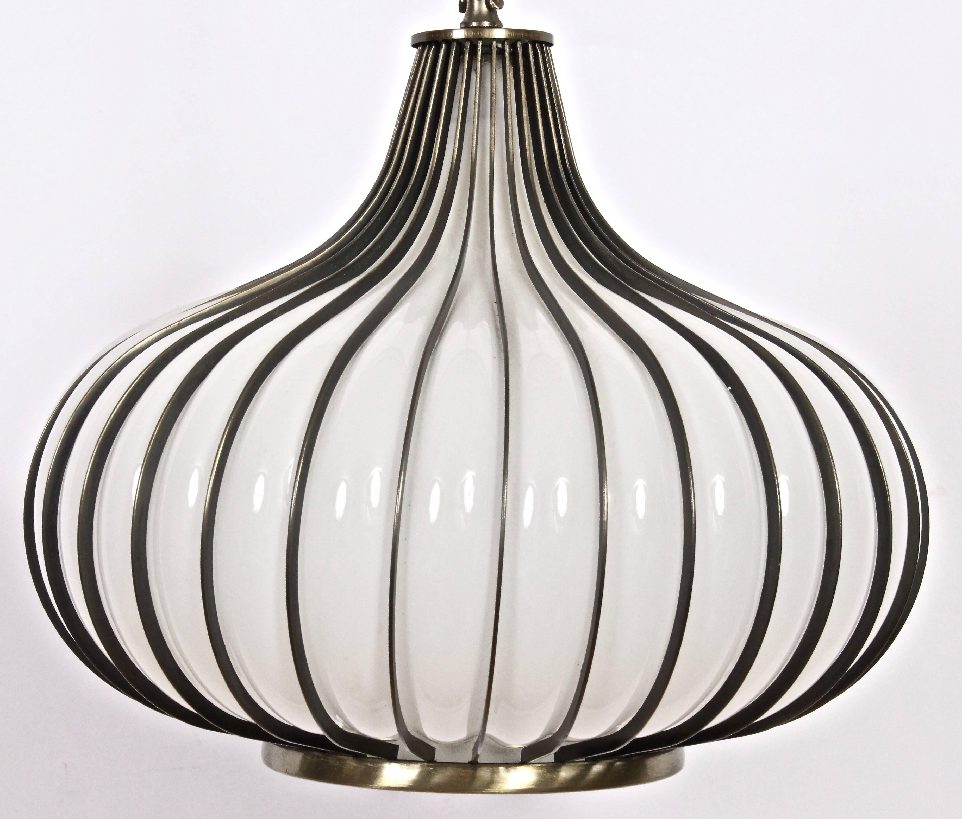 California Modern translucent White Glass Hanging Onion Pendant with Brass surround. Featuring a hand blown White glass Garlic bulb form with ribbed Brass plated Steel detail. With Brass plated 14 foot length chain and 16 foot length clear nylon