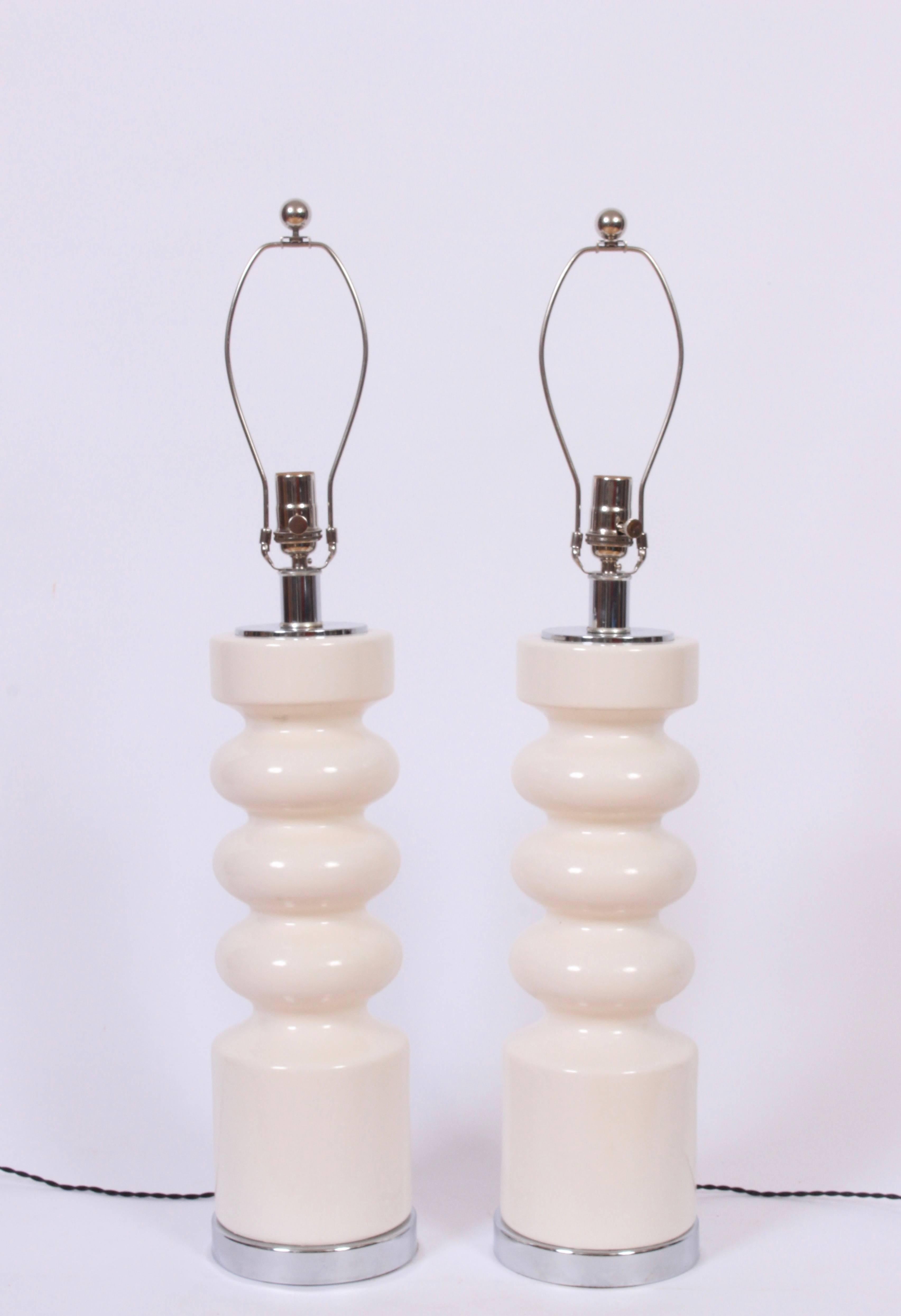 Large pair of Modern Laurel Lamp company stacked off-white ceramic and chrome table lamps. Reflective triple orb form in glazed creamy white ceramic with chrome base and cap. 
24H to top of socket. Shade shown for display only (10 H x 18 D top x 19
