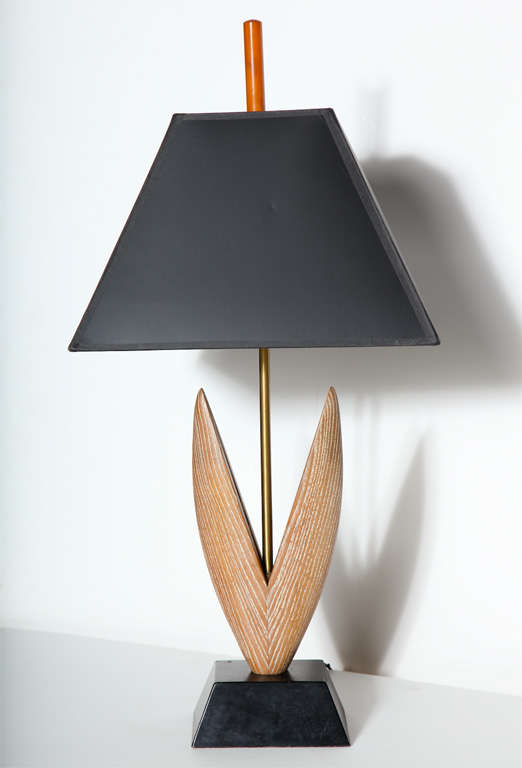 Pair of Yasha Heifetz hand sculpted botanical cerused oak, black and brass table lamps, 1950's. Featuring limed oak leaf form carvings, brass centre column, angled black enameled wooden base, new black paper shades with rust Bakelite finial.
