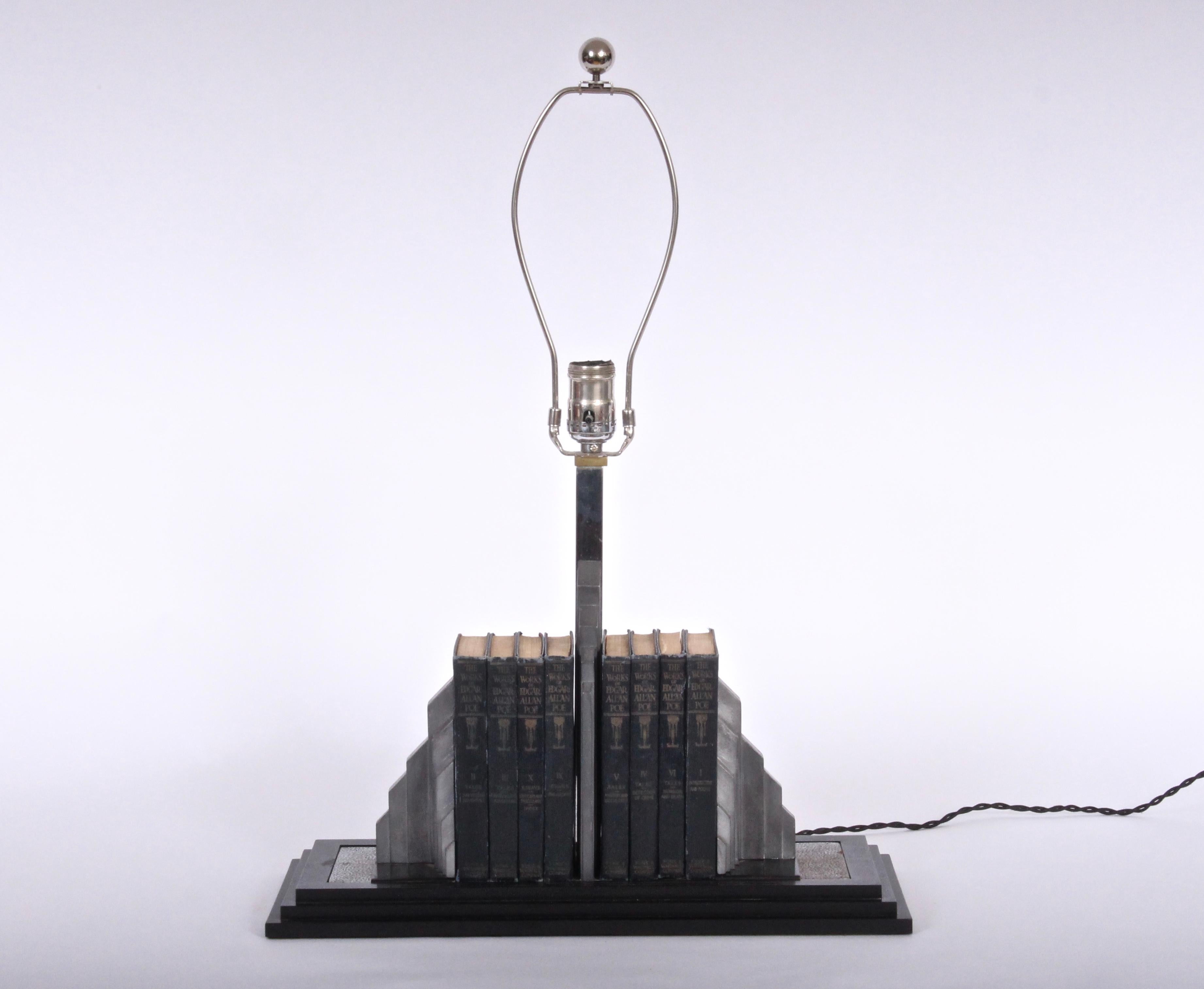 Art Deco Manufacturers Finishing Company, Lib-O-Lite library bookend desk lamp.  Featuring skyscraper form, spring loaded cast aluminum rectangular black bakelite step base with nickel-plated brass textured surface. With wear to plate. Shade shown