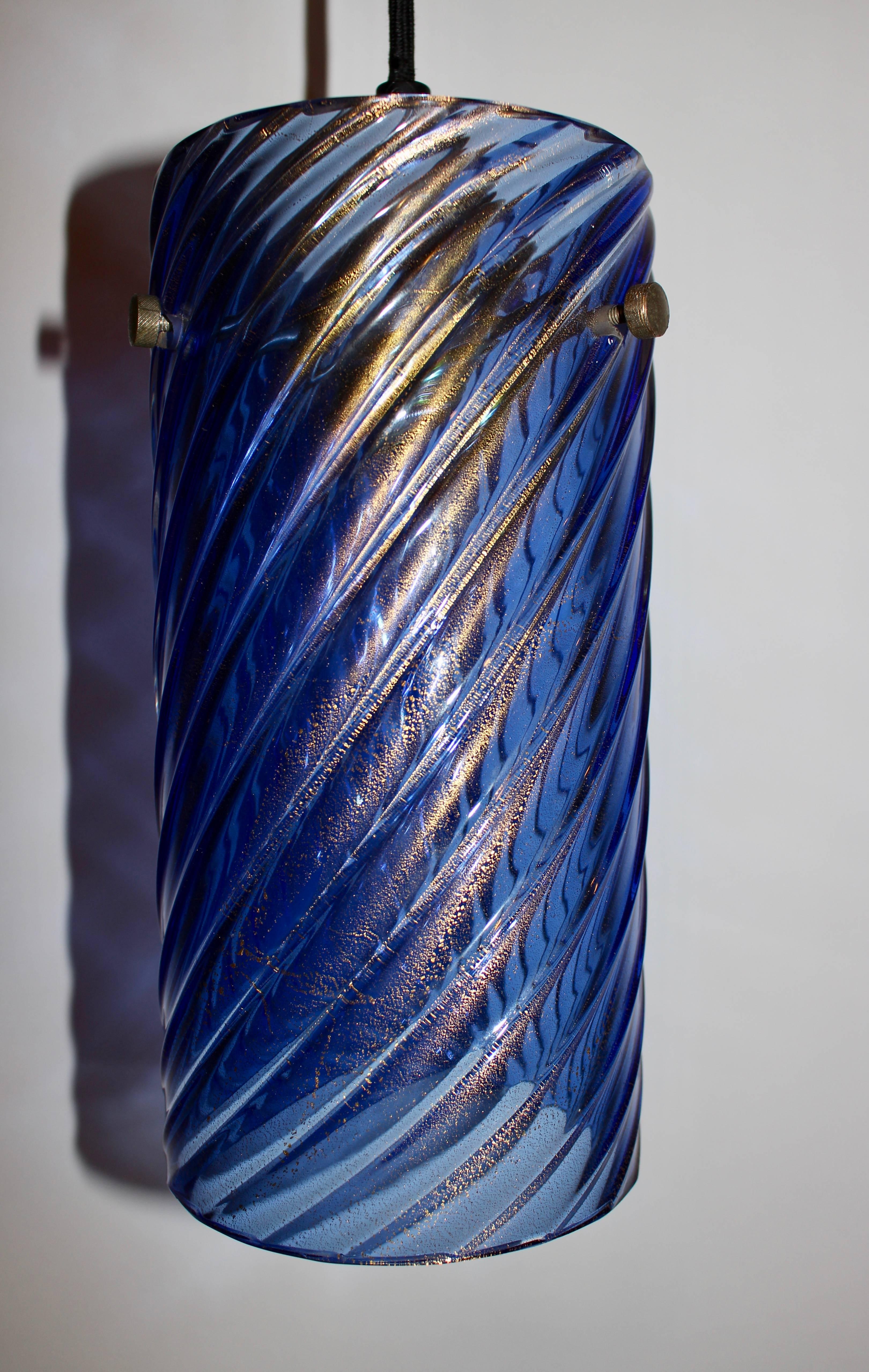 Slim, ribbed Venetian Glass Spiral Twist Blue and Gold flecked Hanging Lamp. Featuring a 5D cylinder in translucent Deep Cobalt Blue glass with Gold highlights. With five foot Black cord, nickel-plated 3.5D ceiling cap and socket cover. Ceramic